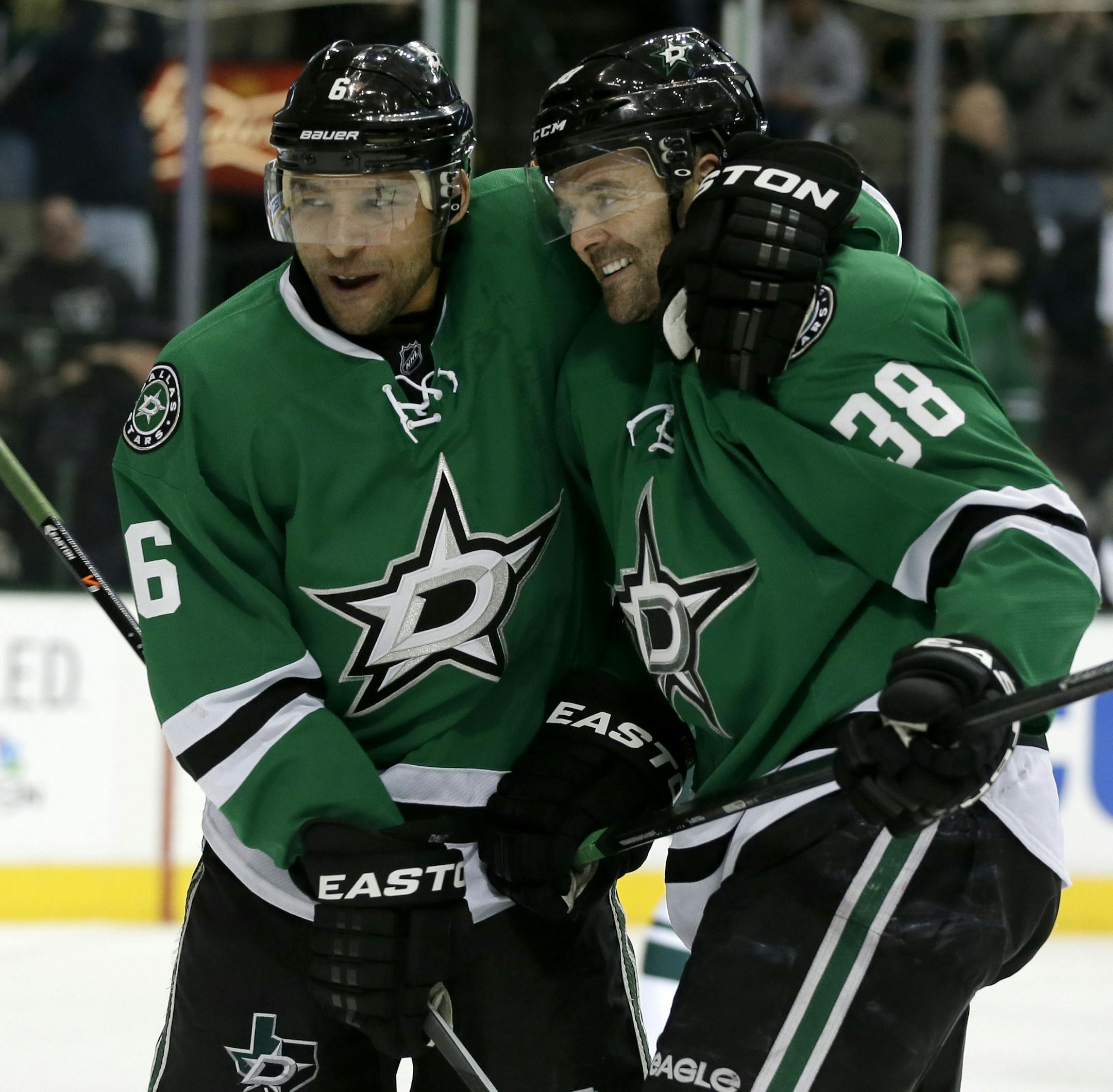 Dallas Stars' Trevor Daley (6) congratulates center Vernon Fiddler (38) on his goal against the Minnesota Wild in the first period of an NHL hockey game, Tuesday, Jan. 21, 2014, in Dallas. (AP Photo/Tony Gutierrez)