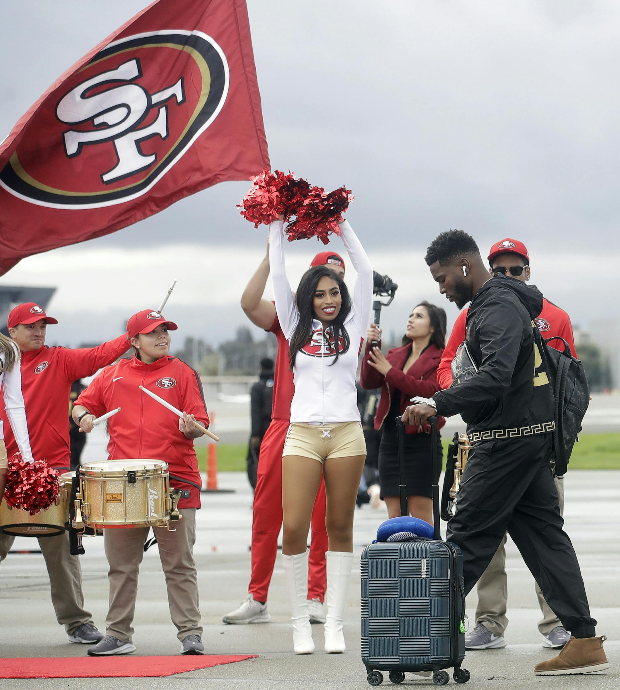 San Francisco 49ers free safety Jimmie Ward, center left, and cornerback Richard Sherman board a plane as the team departs from Mineta San Jose International Airport in San Jose, Calif., for Miami, Sunday, Jan. 26, 2020. The 49ers will face the Kansas City Chiefs in Super Bowl 54. (AP Photo/Jeff Chiu)