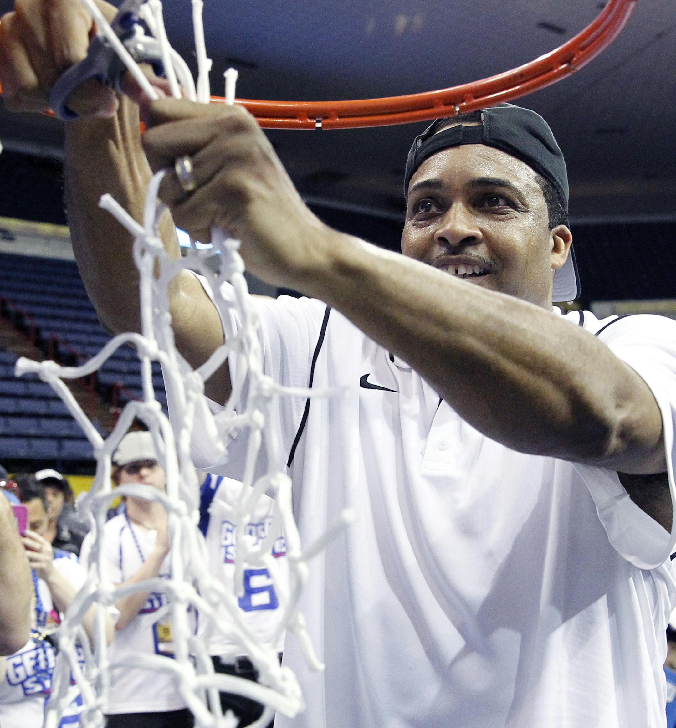 Georgia State head coach Ron Hunter cuts the net after defeating Georgia Southern in the championship of the Sunbelt Conference tournament in New Orleans, Sunday, March 15, 2015. Georgia State defeated Georgia Southern 38-36 for the championship. (AP Photo/Bill Haber)