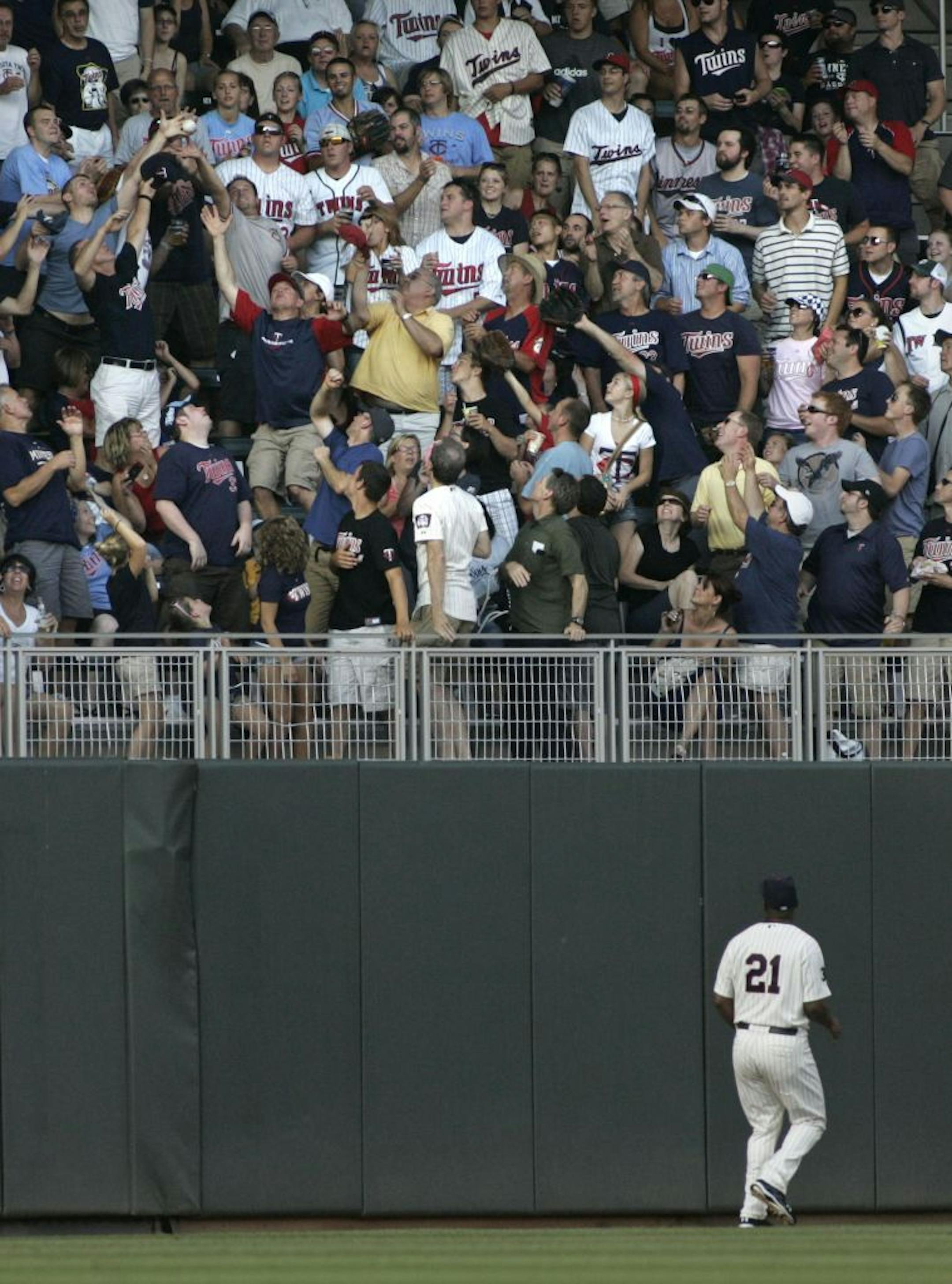 Twin Delmon Young watched the ball reach the stands as Detroit's Ryan Raburn hit a solo homerun in the first inning at Target Field in Minneapolis , Minn., Friday, July 22, 2011.