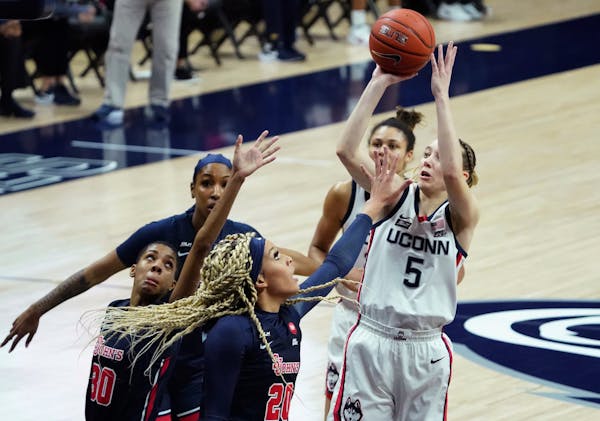Connecticut guard Paige Bueckers (5) shoots against St. John's forward Rayven Peeples (20) during the first half of an NCAA college basketball game We