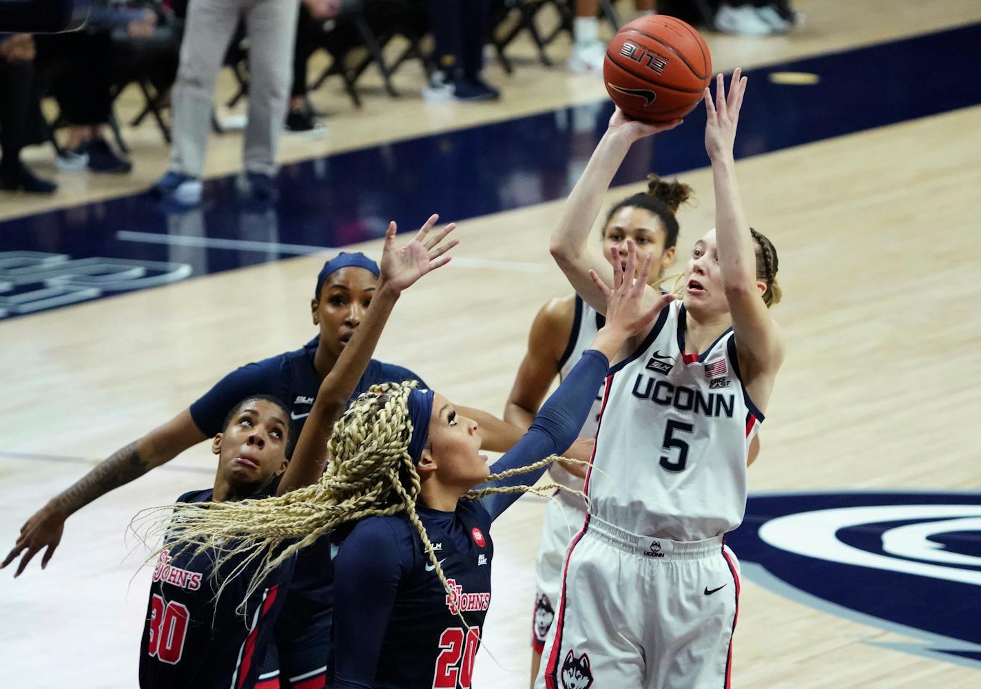 Connecticut guard Paige Bueckers (5) shoots against St. John's forward Rayven Peeples (20) during the first half of an NCAA college basketball game Wednesday, Feb. 3, 2021, in Storrs, Conn. (David Butler II/Pool Photo via AP)