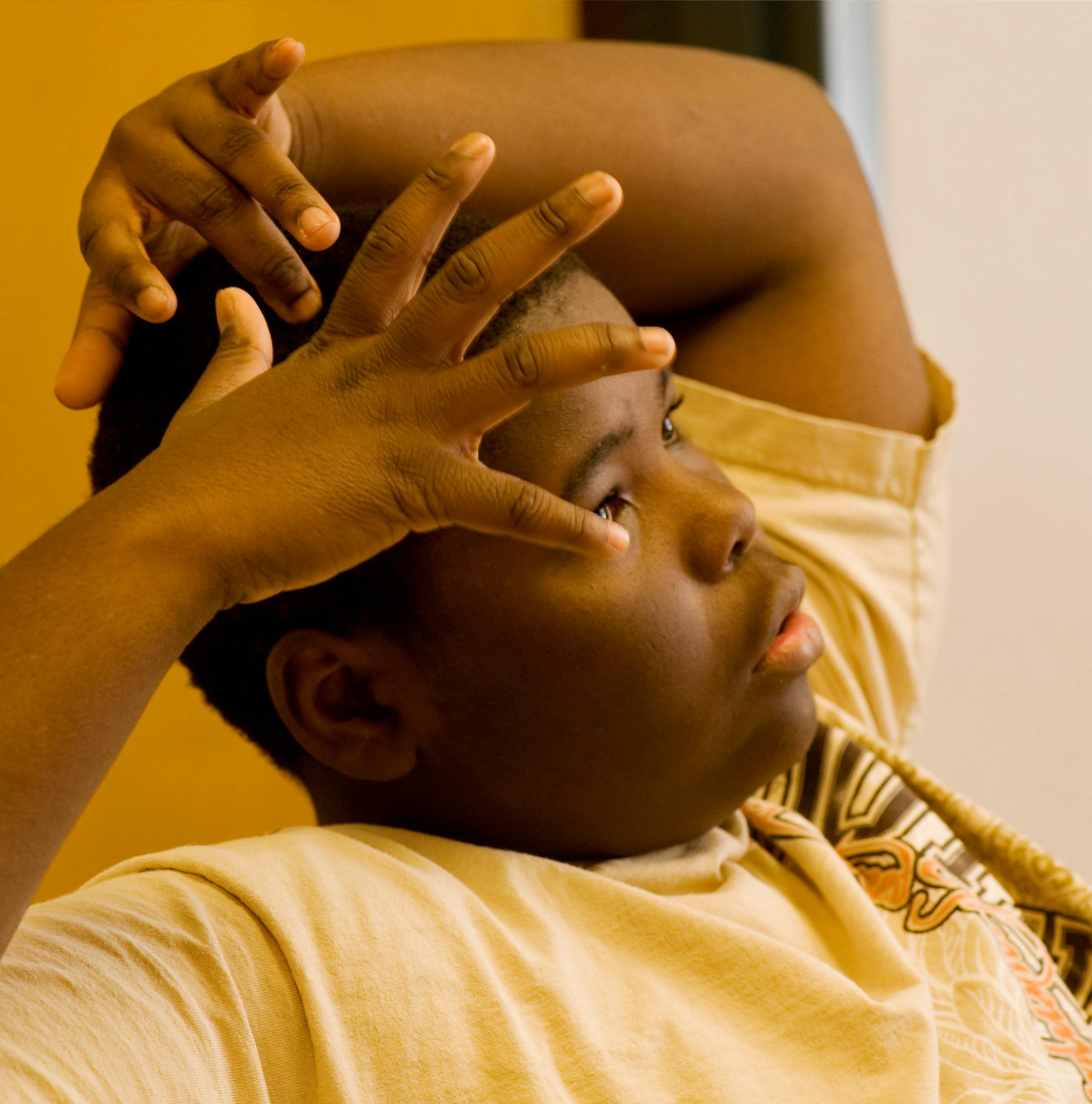 Randy Newell scratches his head and gestures during a discussuion with mentor Melvin Henderson.