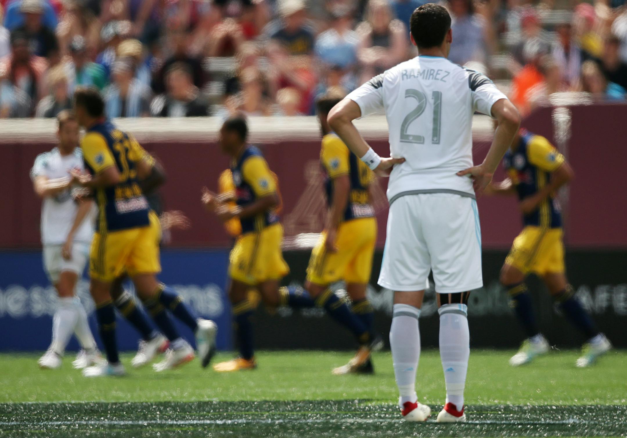 Minnesota United forward Christian Ramirez (21) watched as New York Red Bulls players celebrated a goal in the first half. ] ANTHONY SOUFFLE ï anthony.souffle@startribune.com Game action from an MLS game between the Minnesota United and the New York Red Bulls Saturday, July 22, 2017 at TCF Bank Stadium in Minneapolis.
