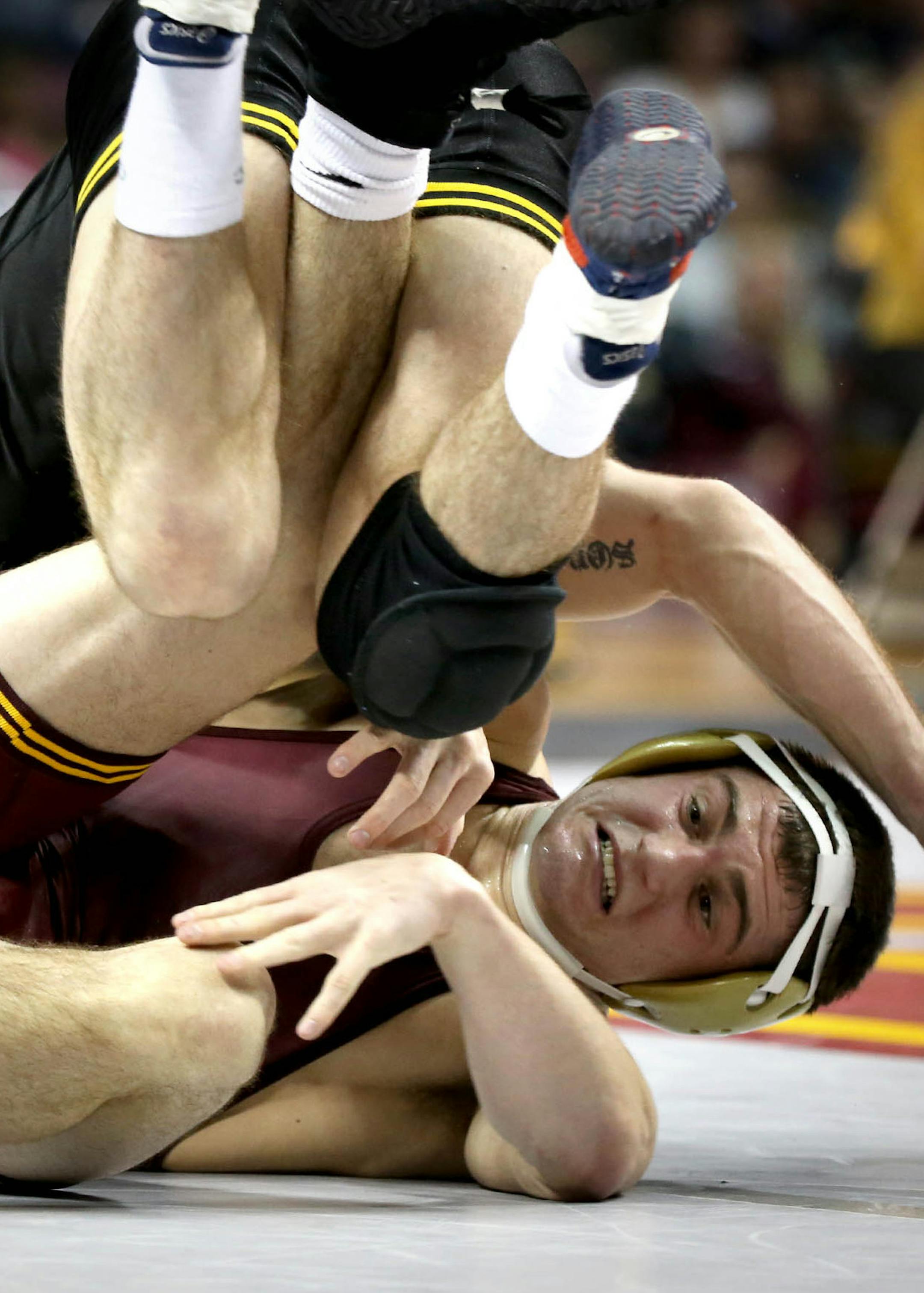 Gopher Jake Short attempted to escape a rollover by Iowa's Brandon Sorensen in the 149 weight class. ] (KYNDELL HARKNESS/STAR TRIBUNE) kyndell.harkness@startribune.com Gophers vs Iowa wrestling meet at Williams Arena inMinneapolis Min., Friday, January 30, 2015. Iowa won over Minnesota 23-12. ORG XMIT: MIN1501302057338278