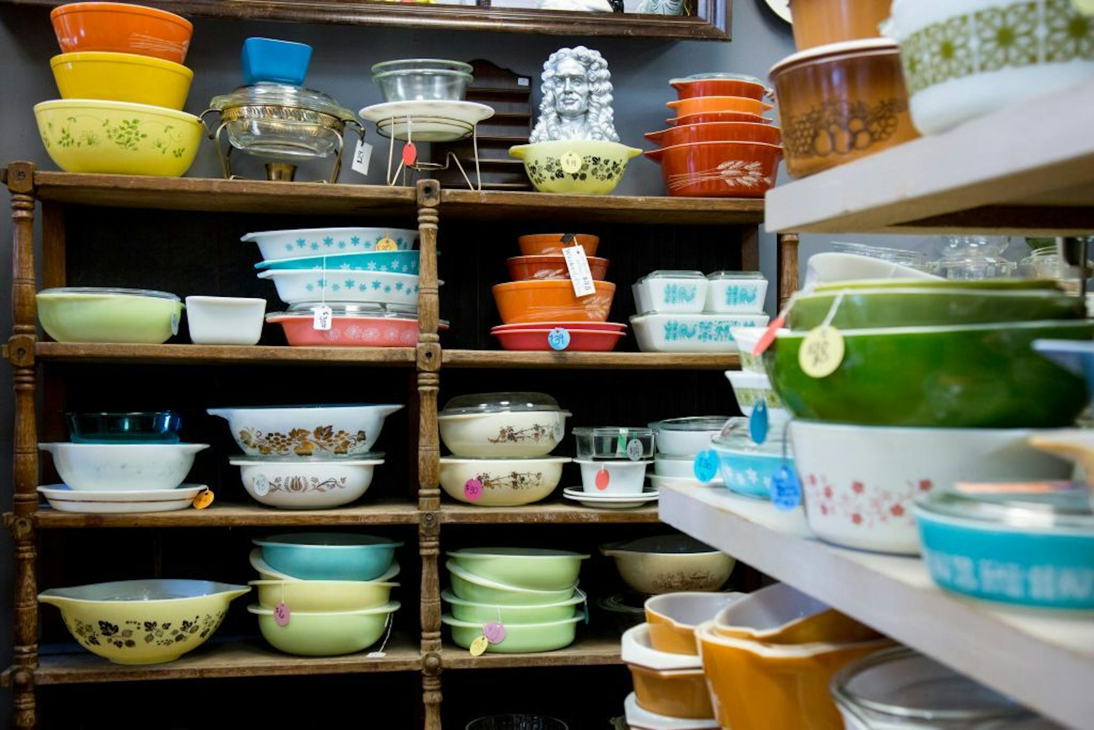 Stacks of colorful Pyrex casseroles and mixing bowls at Turquoise Vintage.