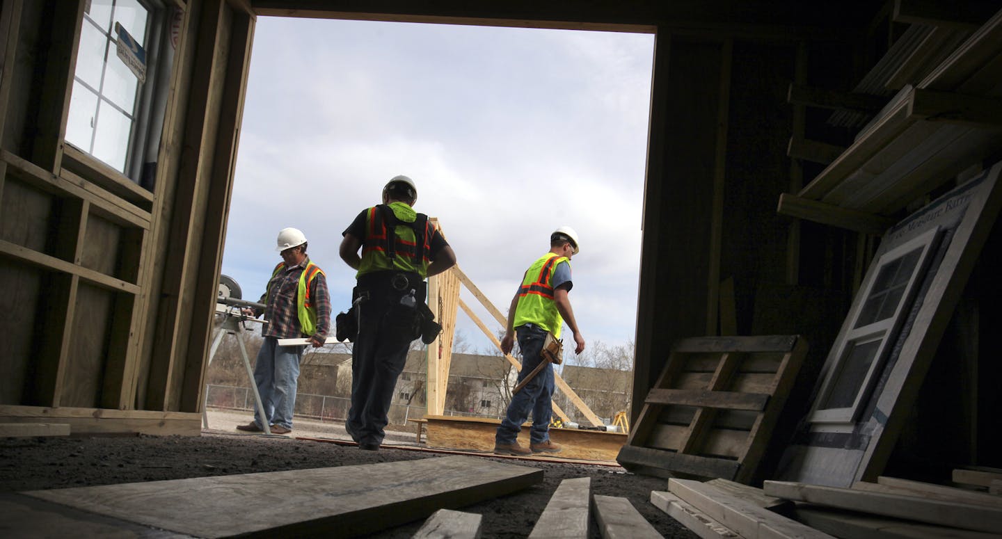 Carpentry Contractors Co.is looking to hire more than 100 workers, but finding people who have the right skills has been difficult. CCC has developed its own training program for carpenters who will build wall panels. They were seen training Tuesday, April 30, 2013, in Montrose, MN. Here, CCC master carpenter and instructor Gene Woodcock, left to right, prepares a power mitre box for trim cutting training with participants Cameron Cain, newly hired CCC carpentry help framer and Josh Fortman, car