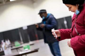 Geetanjali Mittal, right, of SEWA-AIFW received a COVID-19 test, along with James Page of the Cultural Wellness Center, while touring the testing faci