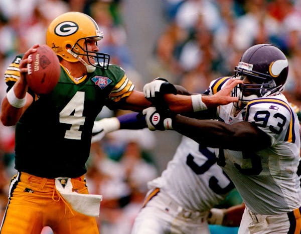 September 5, 1994 Packers quarterback Brett Favre got a handful of John Randle's facemask as he held the Vikings defender at bay to avoid a sack befor