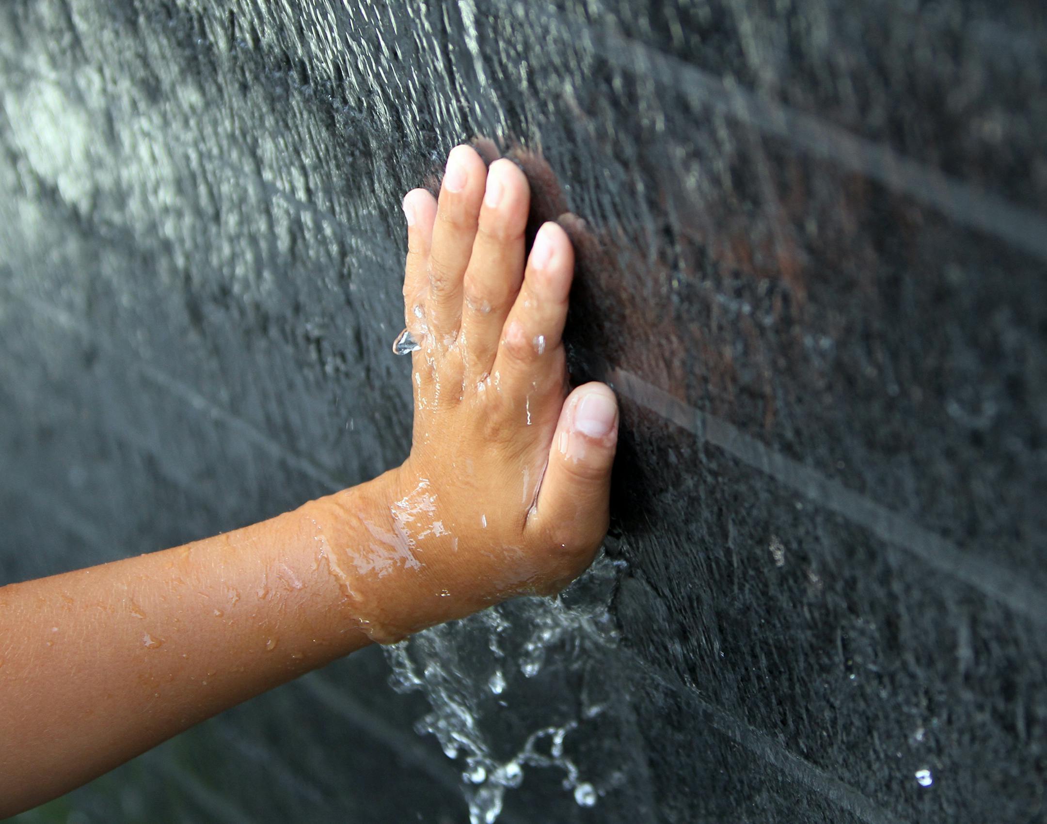 Luis G. Aragon Porcayo touched his name on the survivor wall at the dedication program for the I-35W Bridge Remembrance Garden in Minneapolis, Minn., Monday, August 1, 2011. Luis was on the school bus during the collapse. ] (RENEE JONES SCHNEIDER/STAR TRIBUNE) Luis G Aragon Porcayo (cq on wall) ORG XMIT: MIN2014080512333413