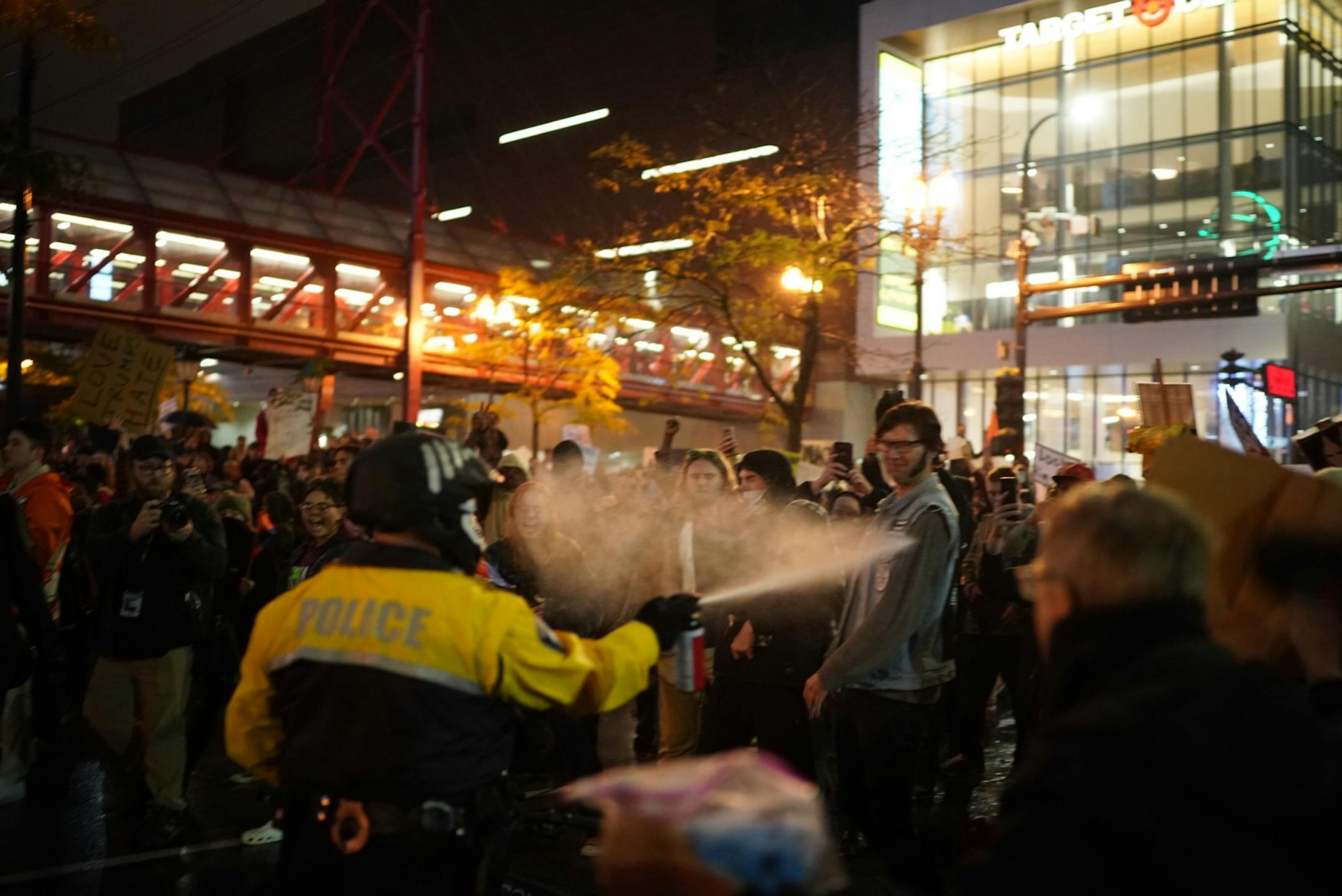 Minneapolis police pepper spray protesters outside Target Center.