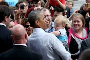 President Barack Obama picked up a baby from the crowd after he spoke at the Lake Harriet Bandshell, Friday, June 27, 2014 in Minneapolis, MN.