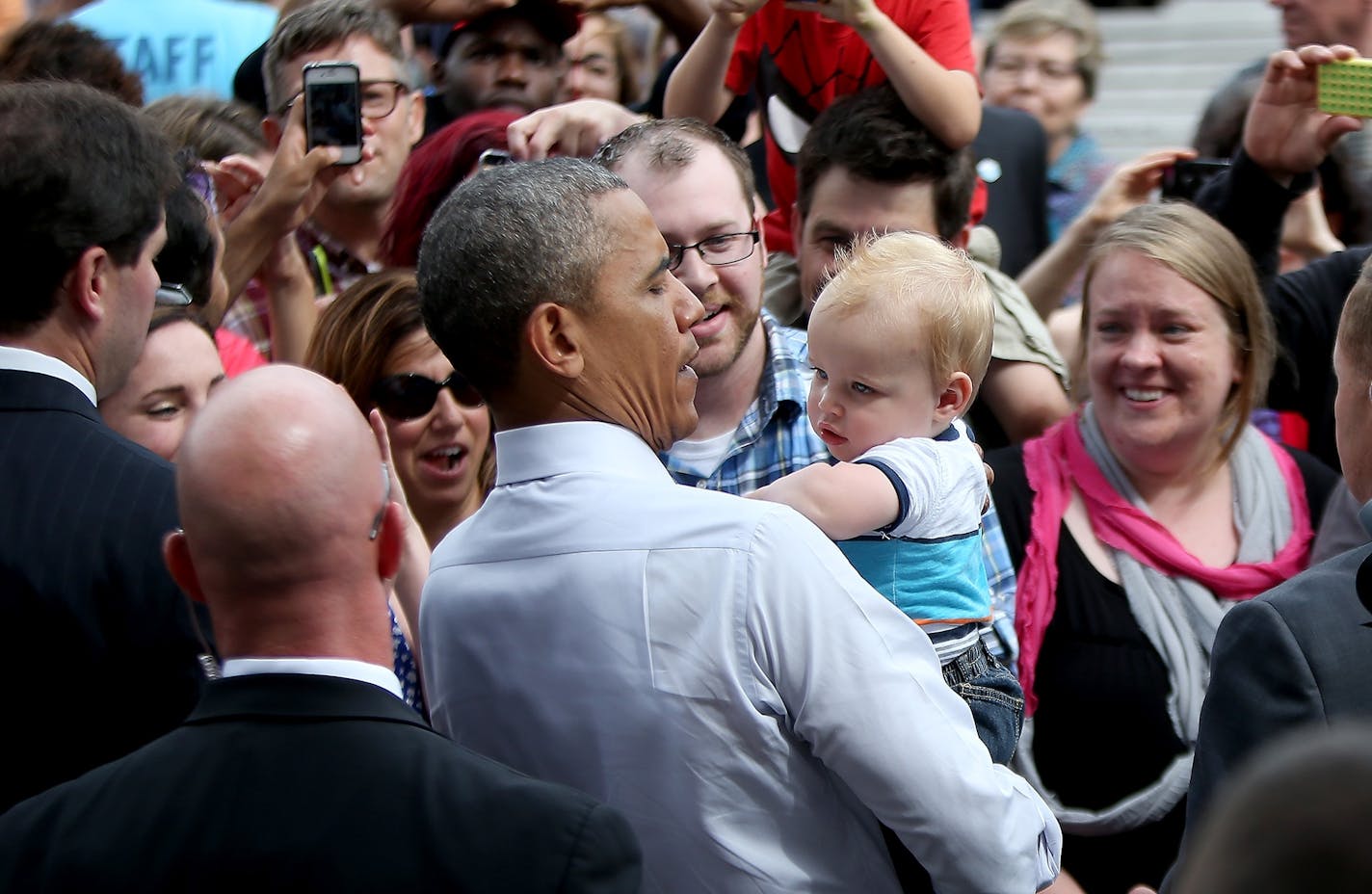 President Barack Obama picked up a baby from the crowd after he spoke at the Lake Harriet Bandshell, Friday, June 27, 2014 in Minneapolis, MN.