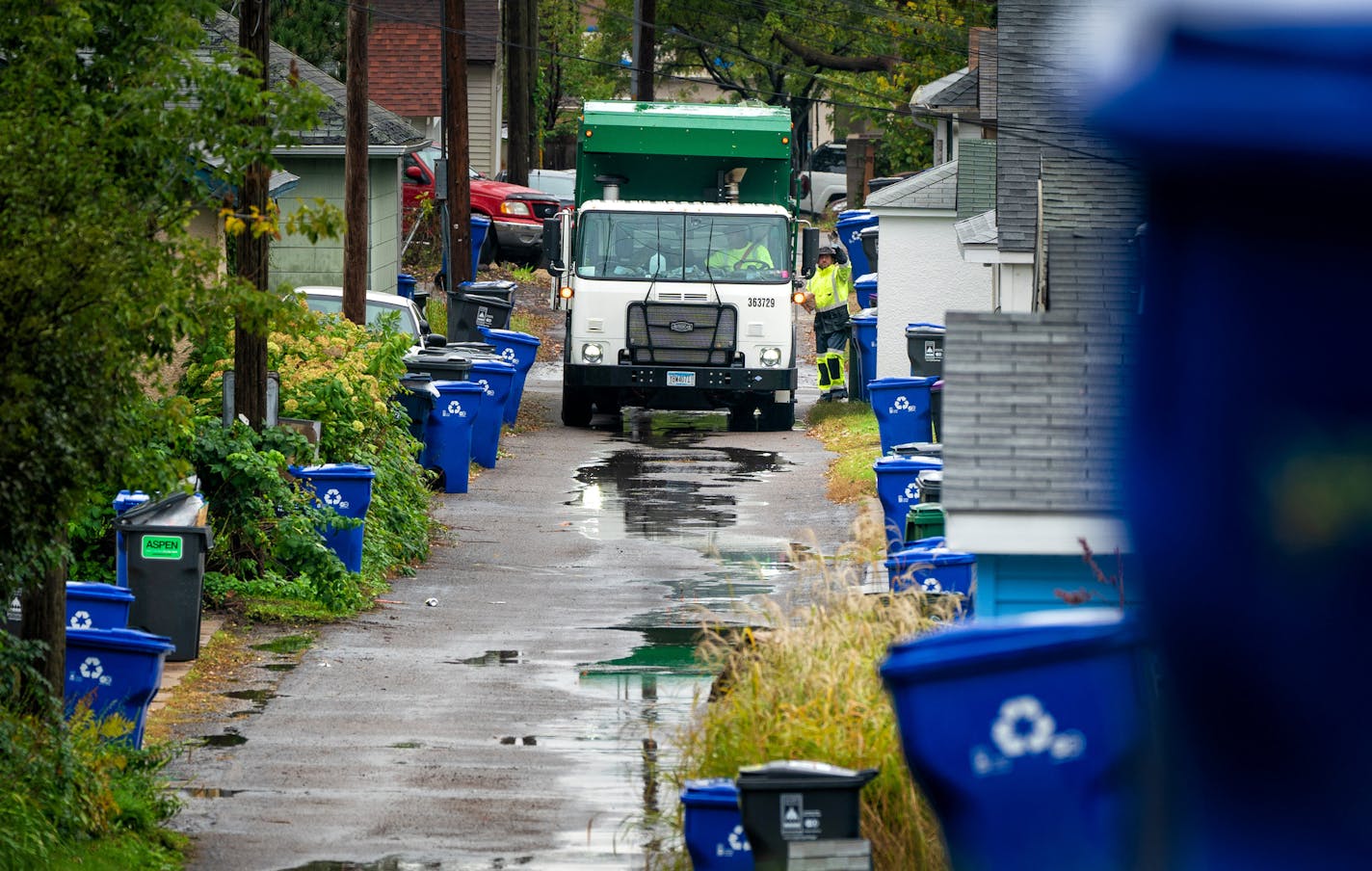 Hauler Daniel Westerhaus emptied new bins in the Snelling-Hamline area of St. Paul on Monday, the first day of organized trash collection.