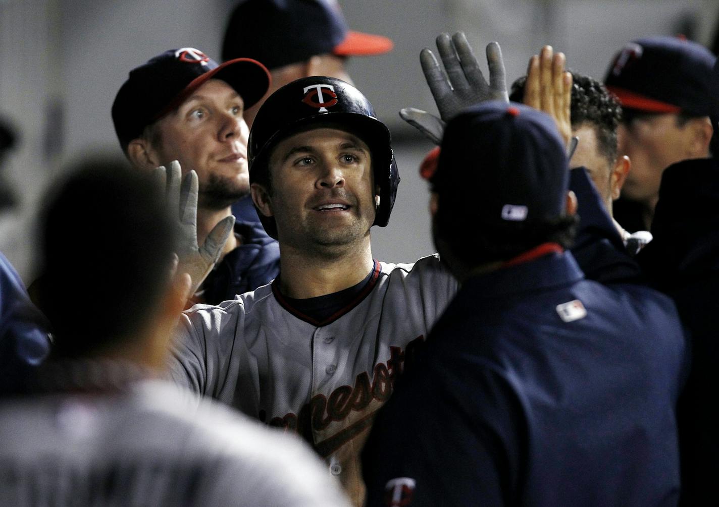 Minnesota Twins' Brian Dozier celebrates after scoring against the Chicago White Sox during the third inning of a baseball game Tuesday, Sept. 17, 2013, in Chicago.