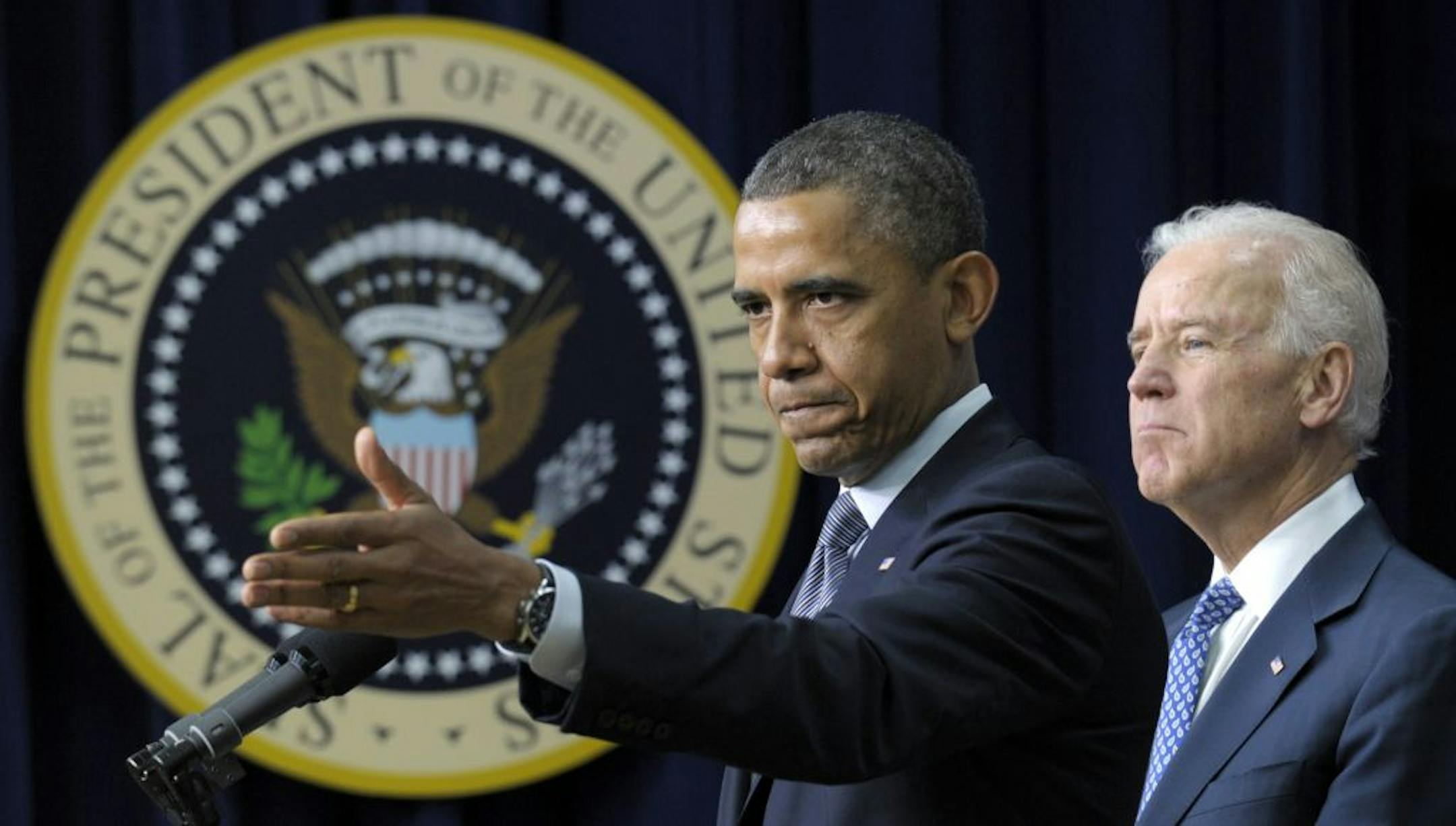 President Barack Obama, accompanied by Vice President Joe Biden, law enforcement officials, lawmakers and children who wrote the president about gun violence following last month's shooting at an elementary school in Newtown, Conn., gestures as he talks about proposals to reduce gun violence, Wednesday, Jan. 16, 2013, in the South Court Auditorium at the White House in Washington.