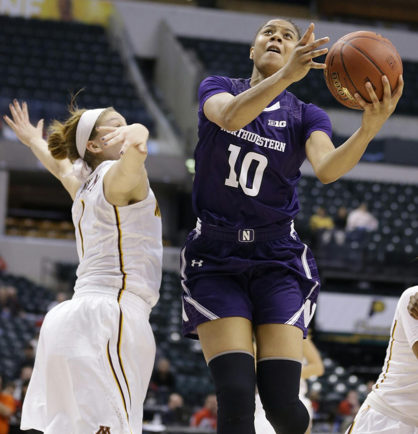 Northwestern forward Nia Coffey (10) shoots over Minnesota guard Rachel Banham (1) in the second half of an NCAA college basketball game at the Big Ten Conference tournament in Indianapolis, Thursday, March 3, 2016. Northwestern defeated Minnesota 84-74. (AP Photo/Michael Conroy)