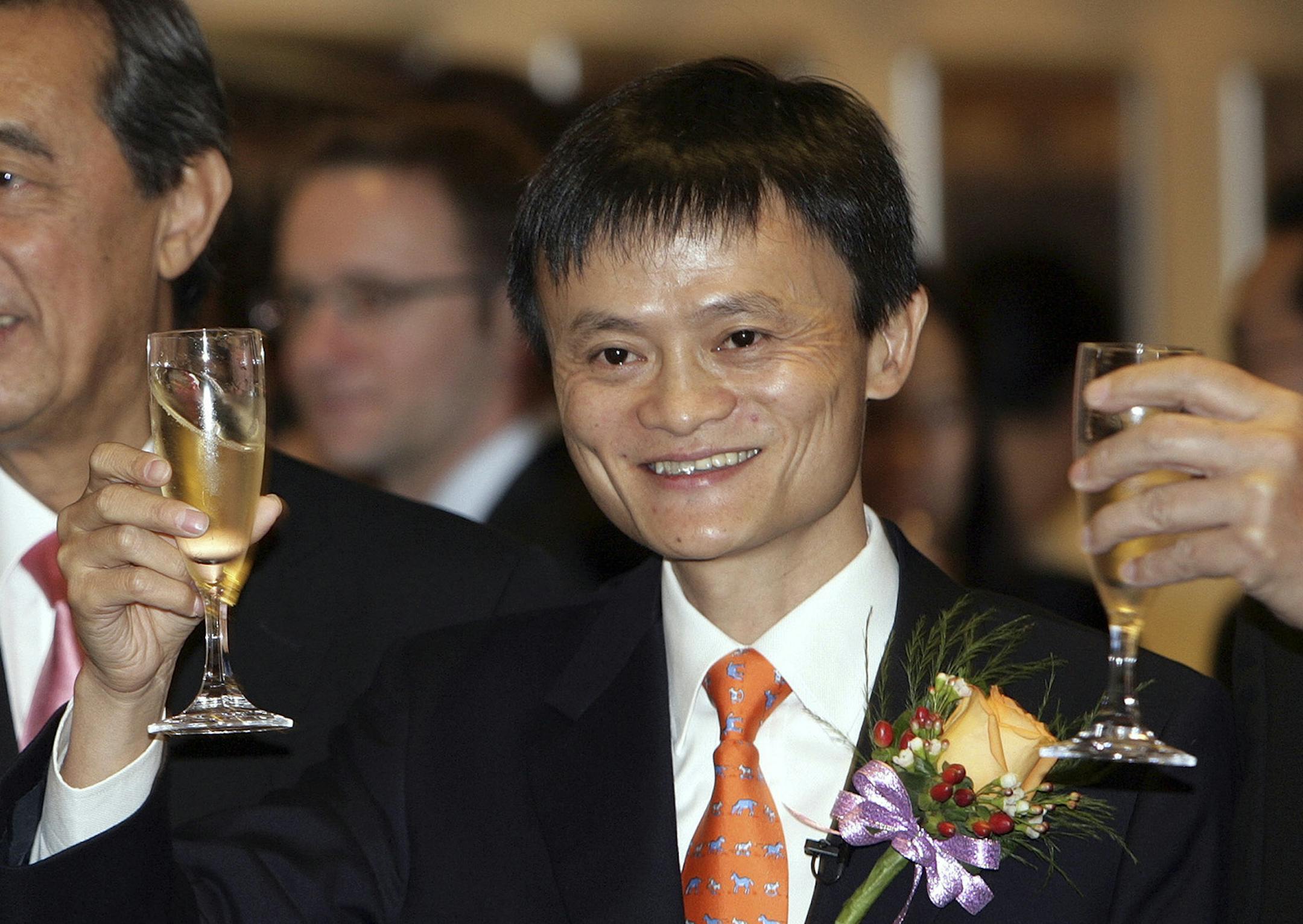 FILE PHOTO: Jack Ma, chairman and then-chief executive officer of Alibaba Group Holding Ltd., right, raises a toast with Ron Arculli, chairman of Hong Kong Exchanges and Clearing Ltd., in Hong Kong, China, on Tuesday, Nov. 6, 2007. Alibaba, which rode China's emergence as an economic superpower over the last 15 years to become a massive online marketplace for everything from forks to forklifts, filed today for what could become the largest U.S. initial public offering ever. Photographer: Daniel