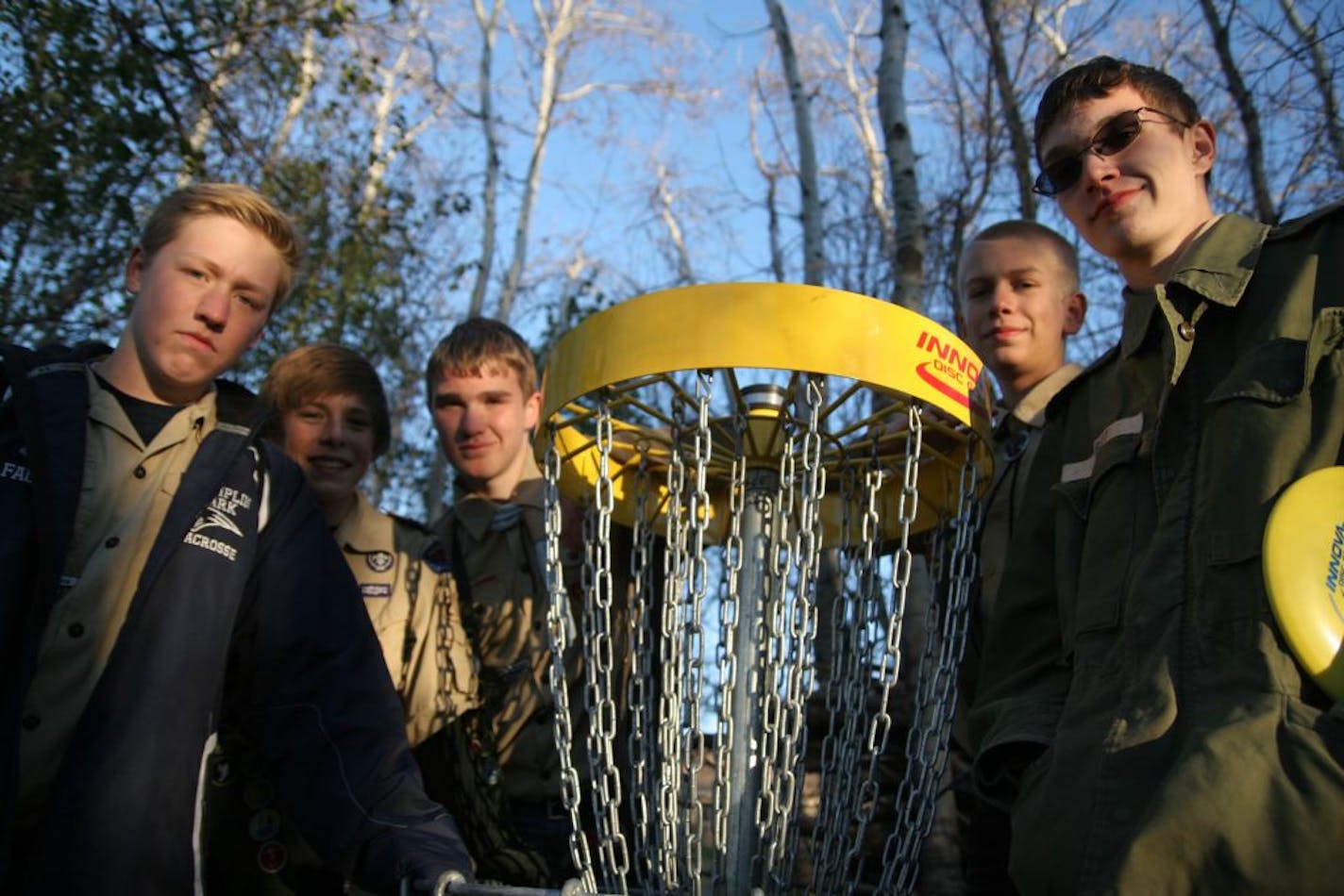 PHOTO BY MARIA BACA. L-R, Danny Faules, 15; Bradey Sullivan, 13; Drew Johnson, 14; David Hubert, 14; and Matthew Hubert, 16, worked together to build Eagle's Ridge disk golf course as their Eagle Scout project. It's rare for scouts to collaborate on a project, but the boys divided the key tasks and worked together on coordinating and fund-raising. The nine-hole course is only the second to be built in Brooklyn Park.