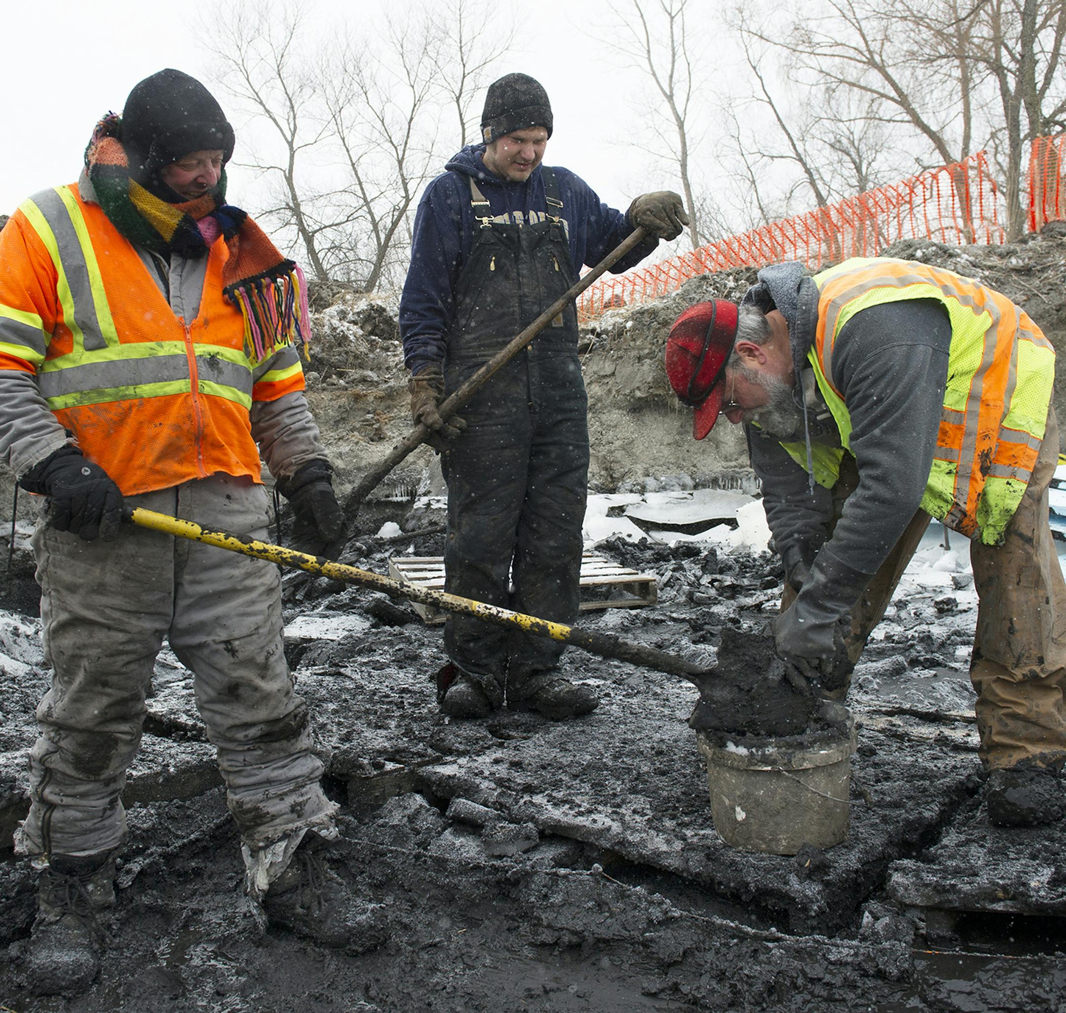 Bob Thompson, Kevin Reider, and James Lindbeck, from left, remove buckets of mucky clay soil during the excavation of an ancient campsite in Chaska, Friday afternoon. ] (Matthew Hintz, 010414, Chaska) ORG XMIT: MIN1401042035251756
