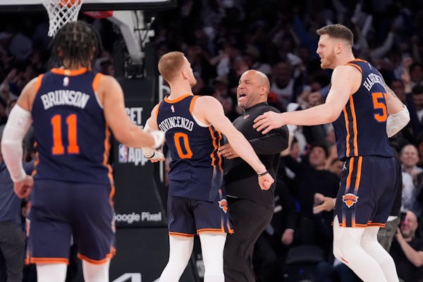 Knicks' guard Donte DiVincenzo (0) celebrates with teammates after hitting a three-pointer late in the second half against the 76ers.