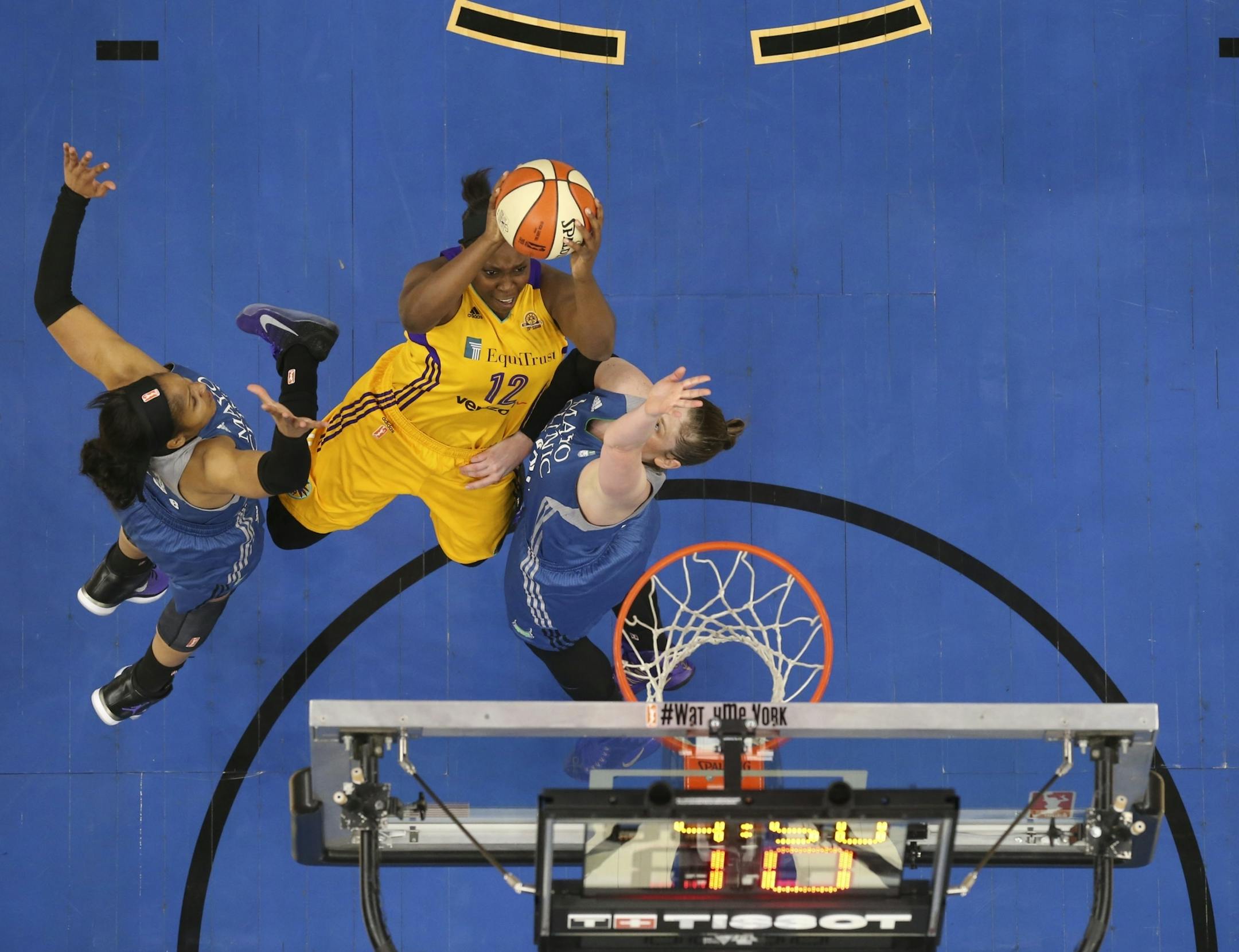 Los Angeles Sparks guard Chelsea Gray (12) put up a second half shot between the defense of Minnesota Lynx forward Maya Moore (23), left, and Minnesota Lynx guard Lindsay Whalen (13).