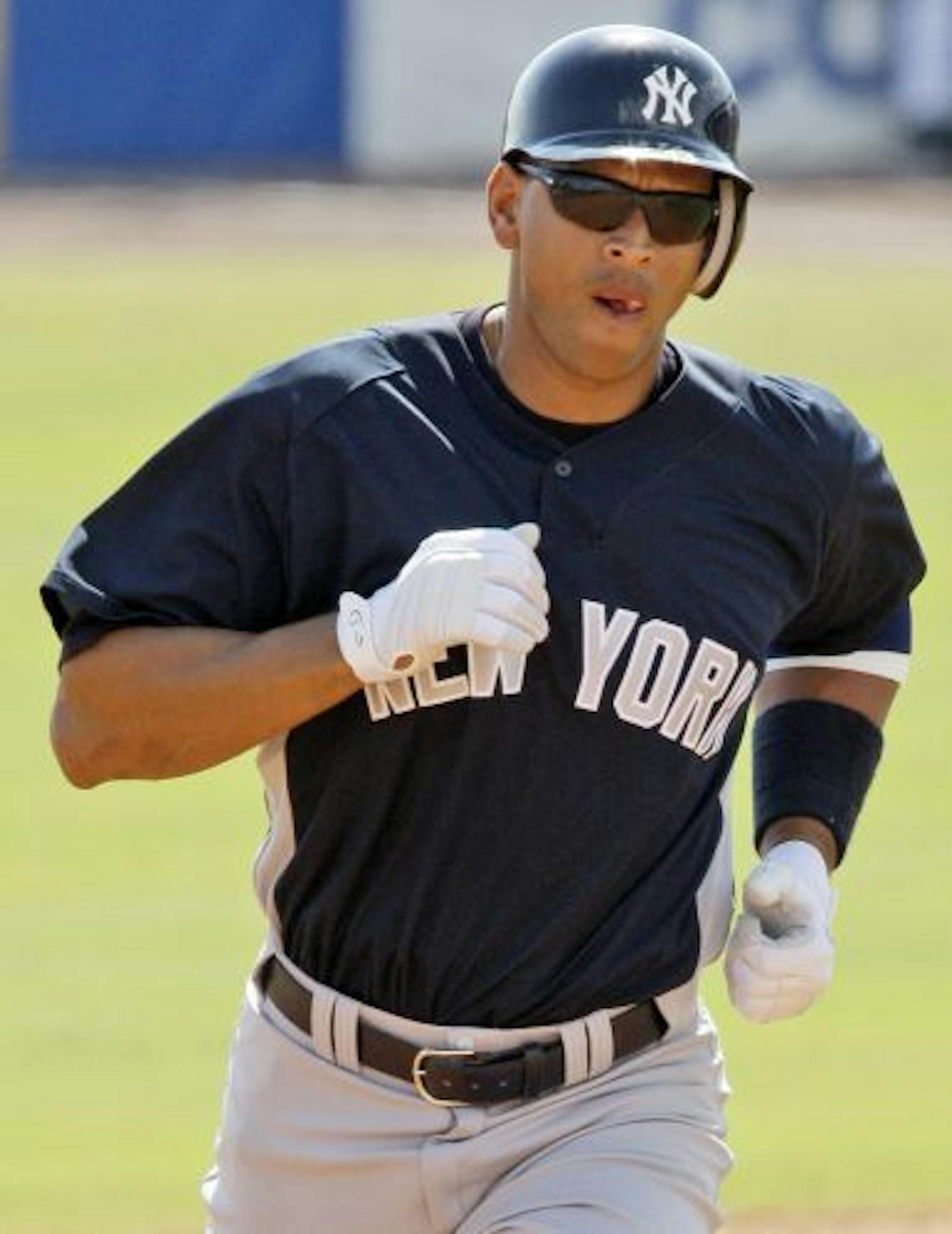 New York Yankees' Alex Rodriguez rounds second base after hitting a two-run, fourth-inning home run off Toronto Blue Jays pitcher Ricky Romero in the first game of the spring training baseball season in Dunedin, Fla., Wednesday, Feb. 25, 2009.