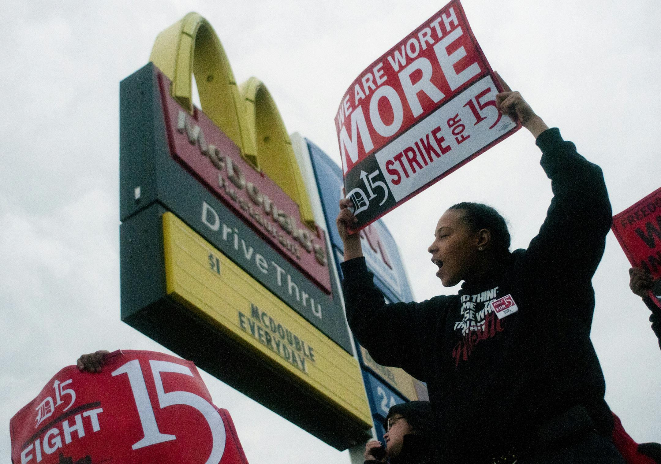 Fast-food worker Michelle Osborn, 23, of Flint shouts out chants as she and a few dozen others strike outside of McDonald's on Wednesday, July 31, 2013 in Flint. Some fast food restaurant workers have walked off the job in the Detroit area as part of an effort to push for higher wages. Organizers say they began the walkout at restaurants in Lincoln Park and Southfield on Tuesday night. Workers in Flint hit the street Wednesday outside a McDonald's, saying they want wages "super-sized." Workers w
