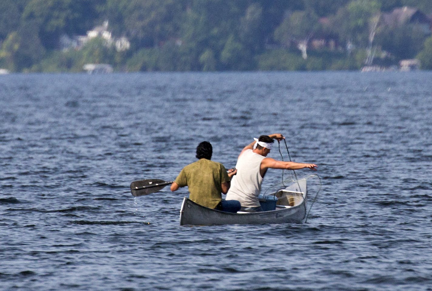 Native Americans Jim Northrup (left) and Todd Thompson, (right) set a gill net on Gull Lake Friday morning. The two were cited for Taking Fish by Illegal Methods and the DNR pulled the nets. ] Two tribal members who attempted to net fish on Gull Lake Friday were chased off the lake and given citations by state conservation officers who then pulled the 200-foot long net from the water and carried it away. Brian.Peterson@startribune.com Nisswa, MN - 8/27/2015