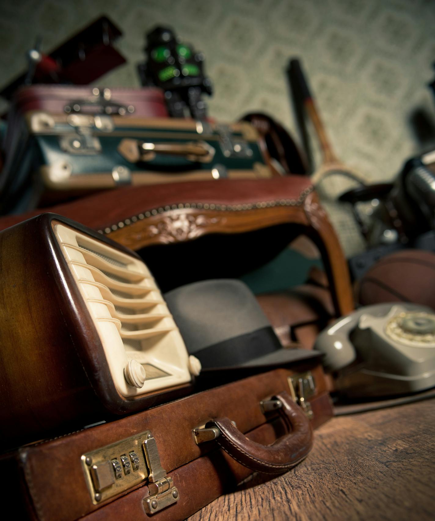 Group of vintage assorted items on attic hardwood floor with vintage wallpaper background. istock photo