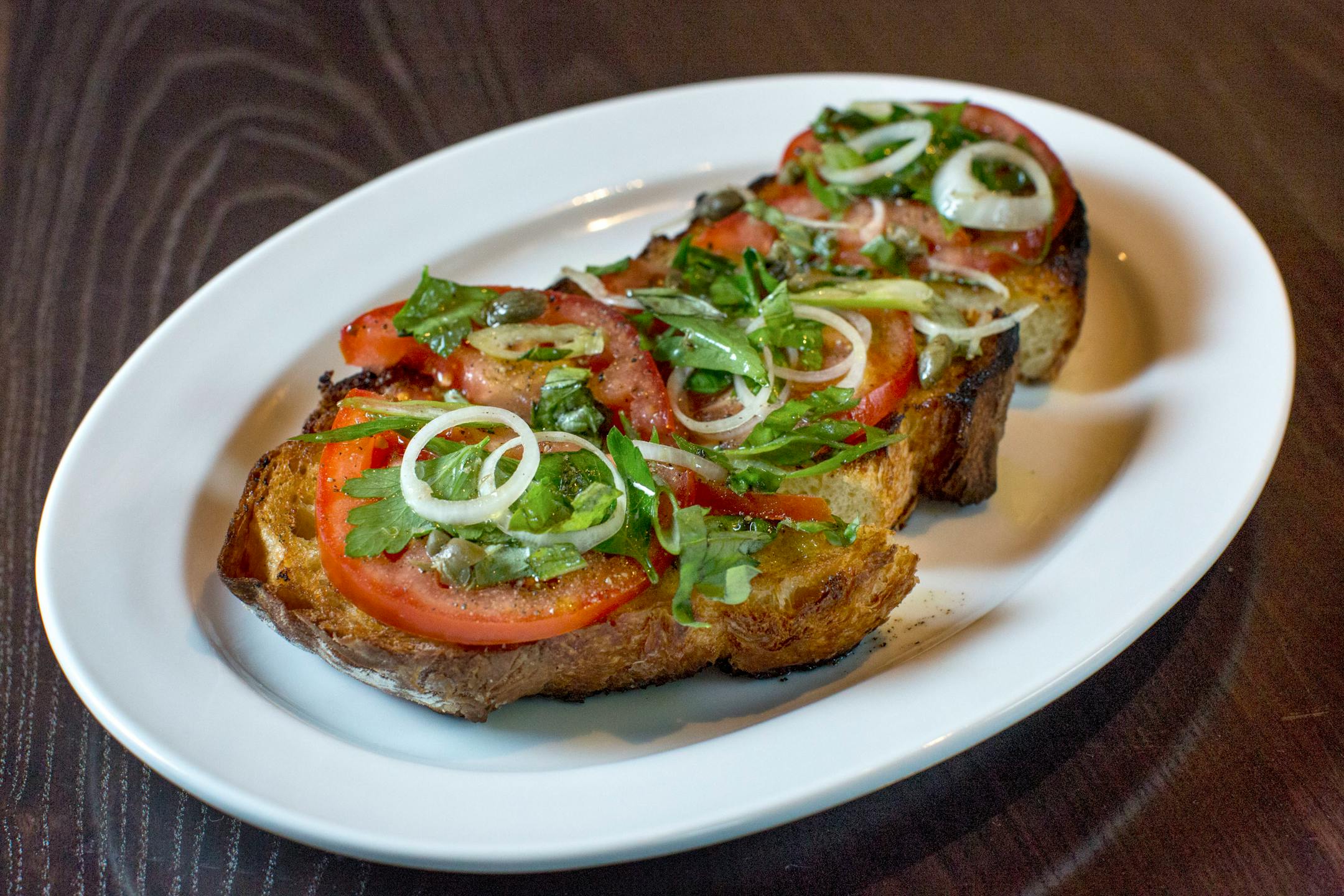 Lovechild serves bruschetta, tomatoes, basil, capers and extra-virgin olive oil. ] COURTNEY PEDROZA • courtney.pedroza@startribune.com June 22-24, 2017; Wisconsin restaurants, cafes, bars, bakeries and breweries; Dining along the Mississippi River.