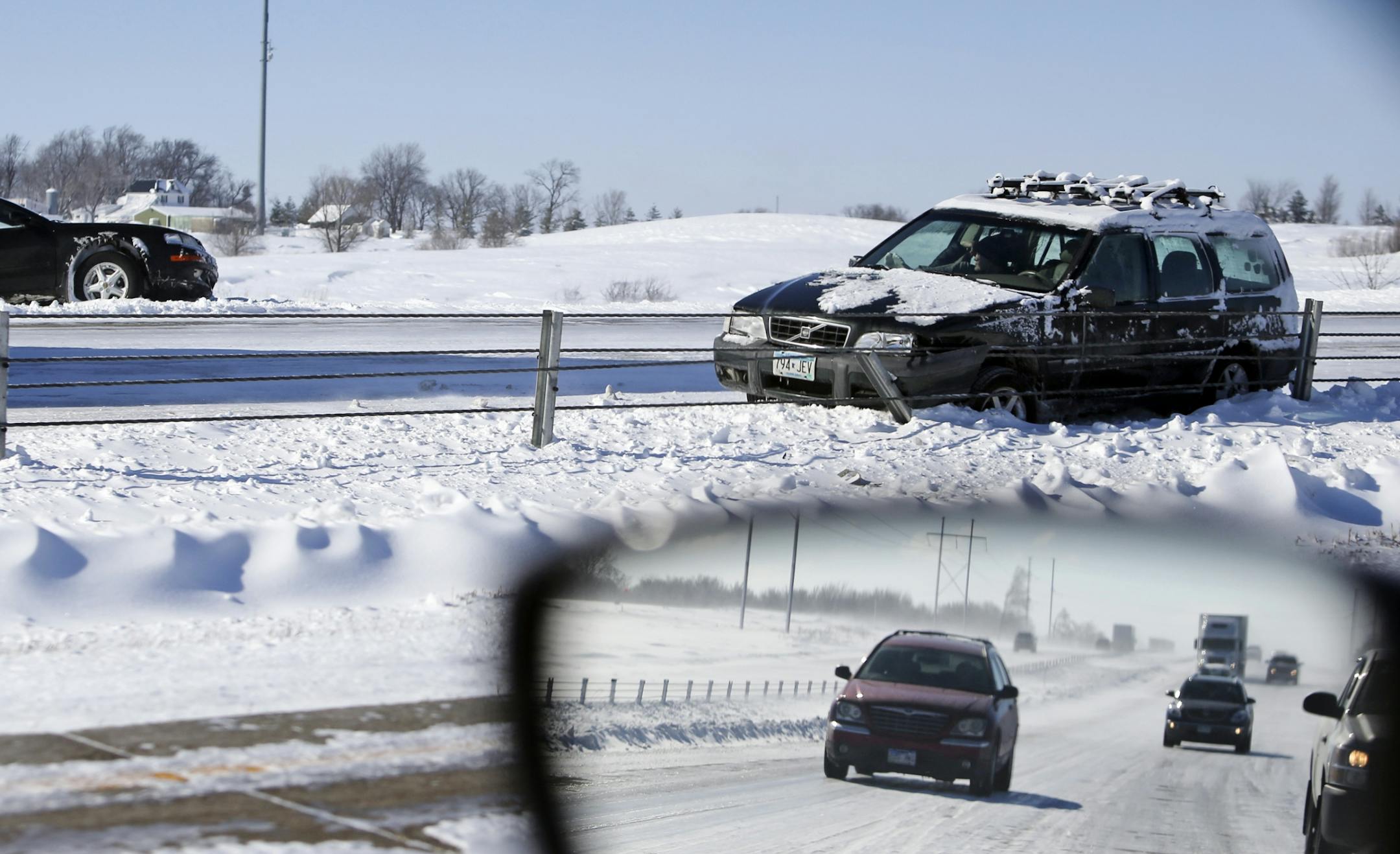 Blizzard-like conditions near along I-35 Friday, Feb. 21, 2014, MN. I-35 to the south at Owatonna, MN into Iowa because of blizzard conditions. Two cars sit in the ditch after having lost control along I-35 southbound between Dundas and Lakeville.