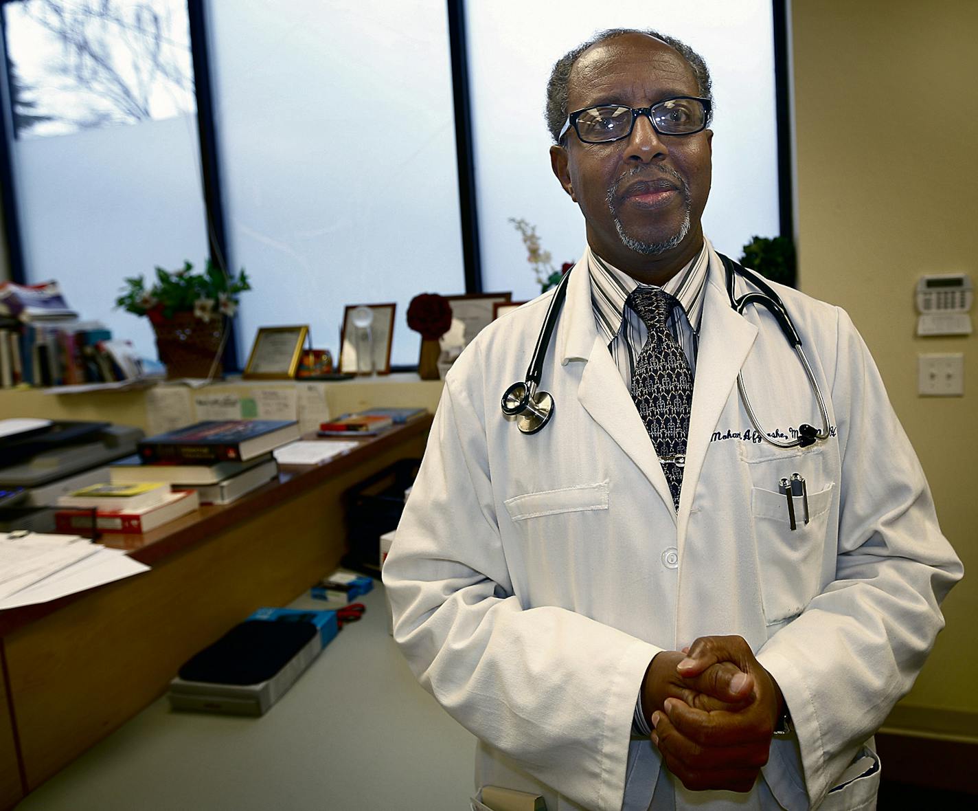 Dr. Mohamud Afgharshe at his clinic, the Gargar Clinic & Urgent Care in Minneapolis. ] JIM GEHRZ &#x201a;&#xc4;&#xa2; james.gehrz@startribune.com / Minneapolis, MN / December 11 2014 /3:00 PM - BACKGROUND INFORMATION: The Somali doctor thought he was doing good works - treating Twin Cities refugees and disabled patients from the Somali community. Imagine his shock when a local lawyer sued him for violating the Americans with Disabilities Act. Imagine his further shock when he discovered the same