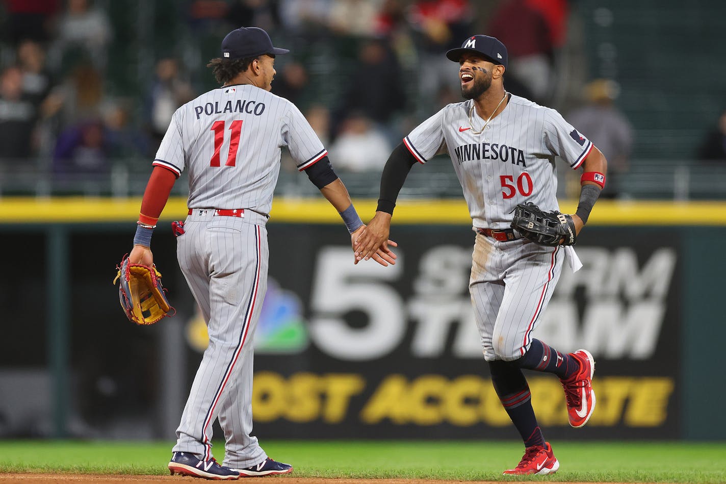 The Minnesota Twins' Jorge Polanco (11) and Willi Castro (50) celebrate after defeating the Chicago White Sox, 10-2, at Guaranteed Rate Field on Thursday, Sept. 14, 2023, in Chicago. (Michael Reaves/Getty Images/TNS) ORG XMIT: 90065305W