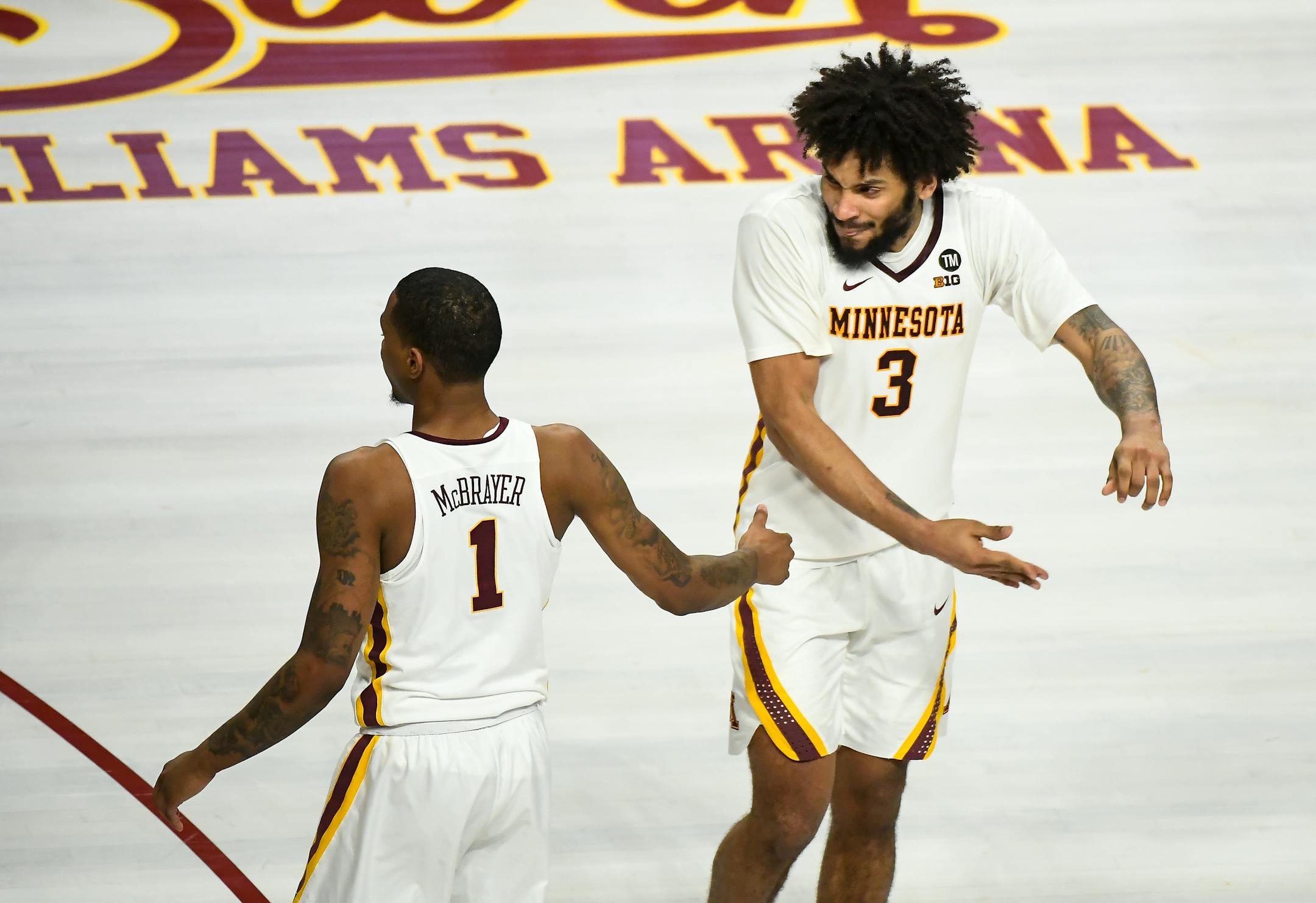 Gophers forward Jordan Murphy (3) high-fived guard Dupree McBrayer (1) after McBrayer was fouled during a three-point attempt in the second half vs. Penn State.