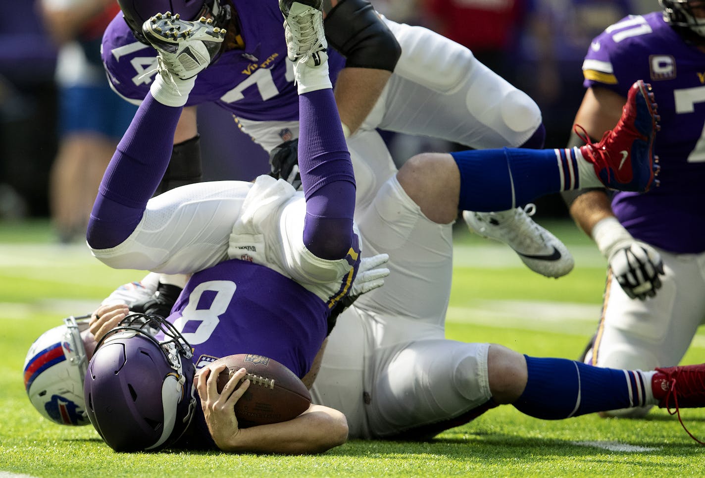 Minnesota Vikings quarterback Kirk Cousins was upended by the Bills' Kyle Williams.