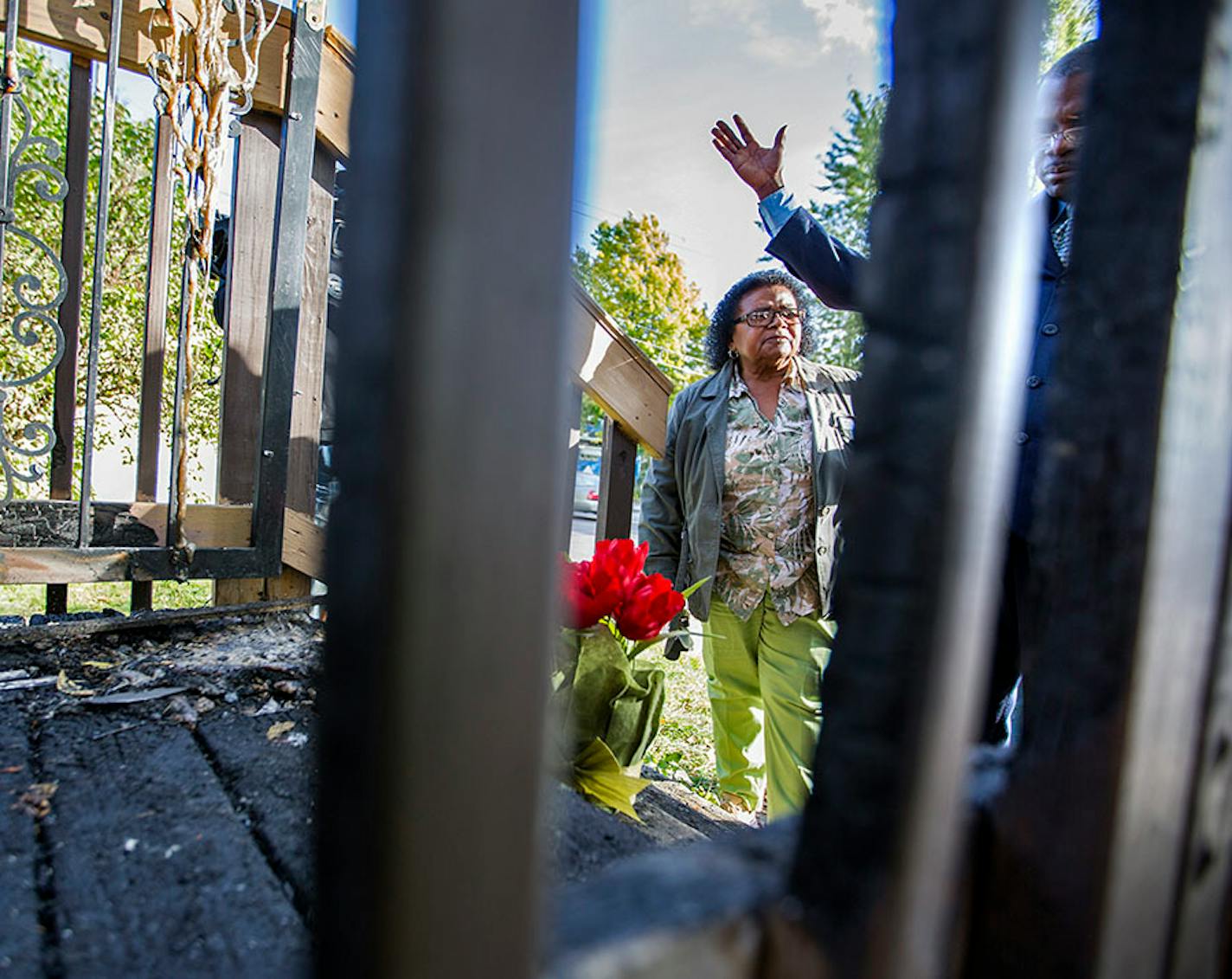 Rev. Annie Hester and John Martin, both community leaders in north Minneapolis, pray at the site of a house fire where three children died on Penn Avenue in north Minneapolis on Sunday, October 4, 2015.