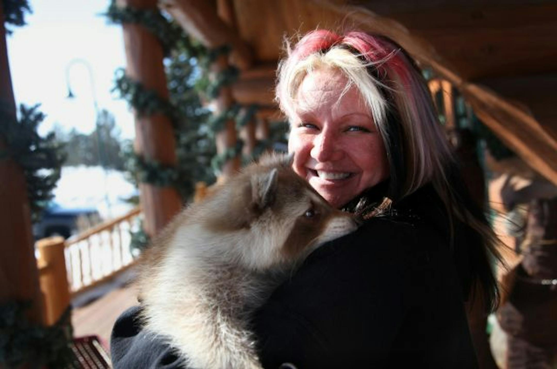 Terri Petter holds her blonde raccoon Fingers at the site of where her wildlife education center will be built.