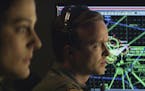 This image released by Bleecker Street shows Phoebe Fox, left, and Aaron Paul in a scene from "Eye In the Sky." (Keith Bernstein/Bleecker Street via A