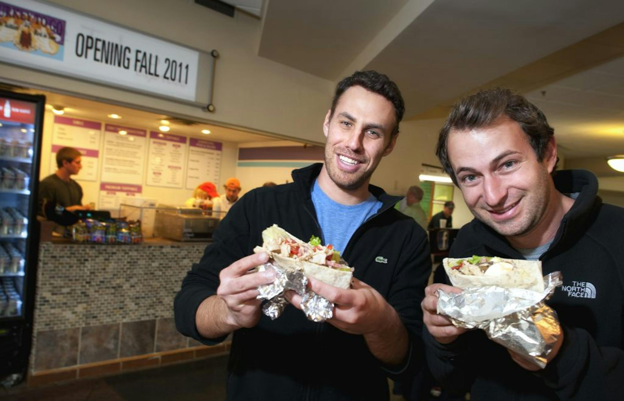 Turkey to Go co owners Drew Levin and Danny Perkins with their signature sandwich, the turkey pita with fresh mozzarella, roasted peppers, grape tomatoes and kalamata olives.
