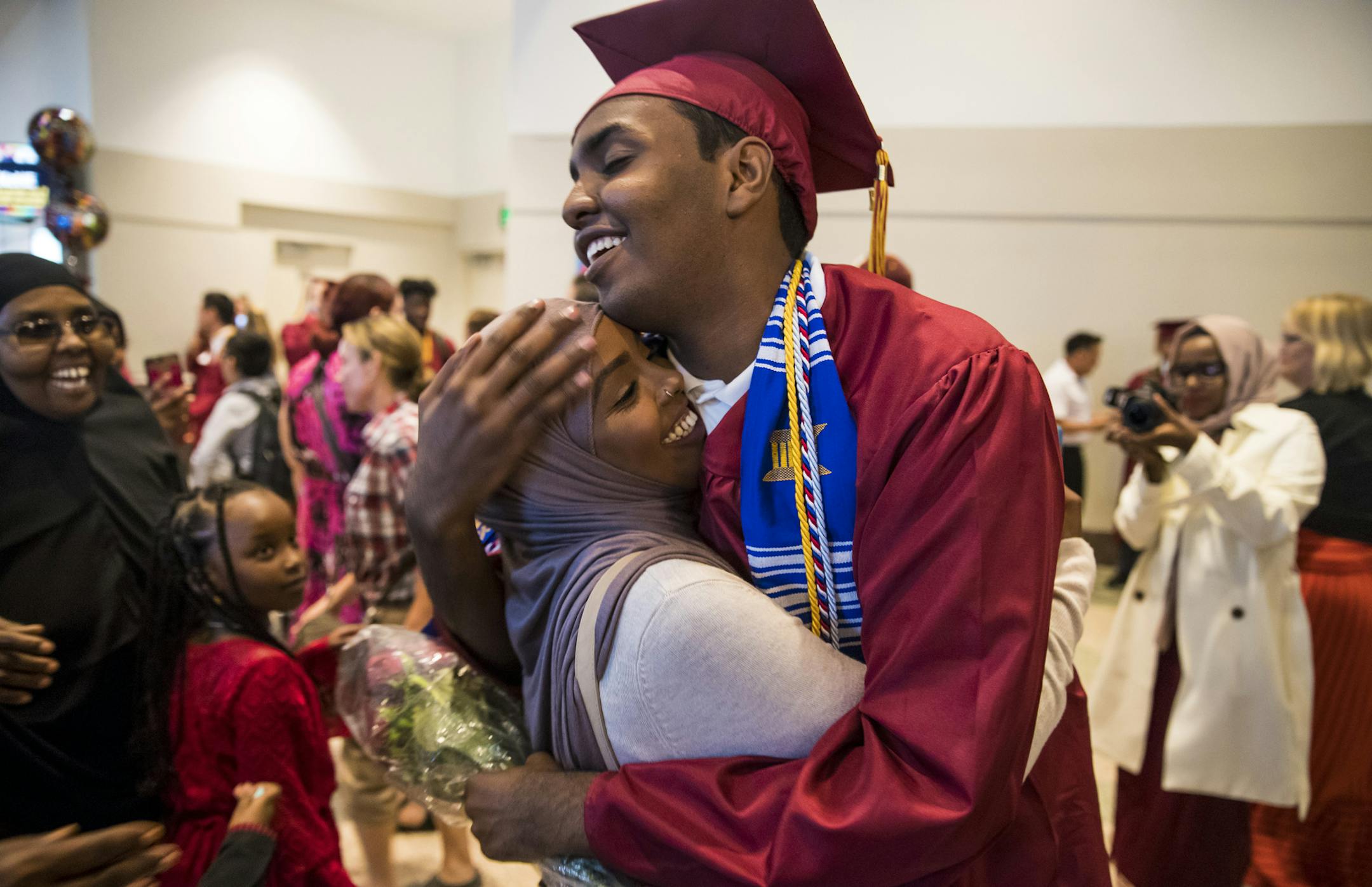 Mohamed Hassan hugged one of his sisters as he was surrounded by family members after his graduation ceremony on June 8, 2017 at the Minneapolis Convention Center in Minneapolis.