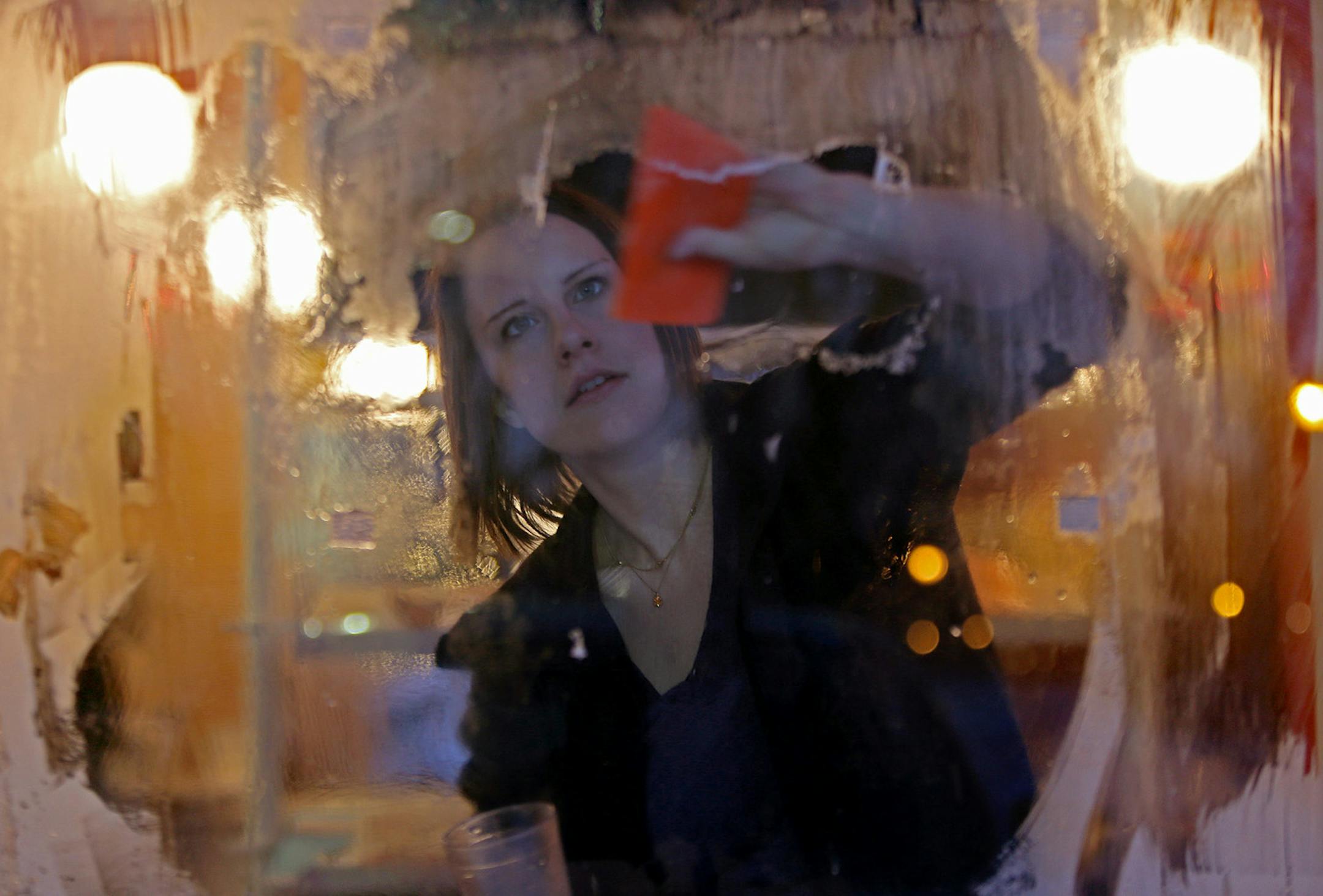 Kati Alarcon was determined to scrape off the ice from a door at Sunstreet Breads Monday, January 27, 2014 in Minneapolis, MN. (ELIZABETH FLORES/STAR TRIBUNE) ELIZABETH FLORES ‚Ä¢ eflores@startribune.com