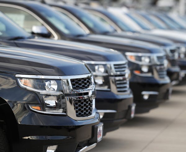 This June 24, 2018, photo shows unsold 2018 Suburbans at a Chevrolet dealership in Englewood, Colo. Automobile sales in the U.S. fell 2% in the first 