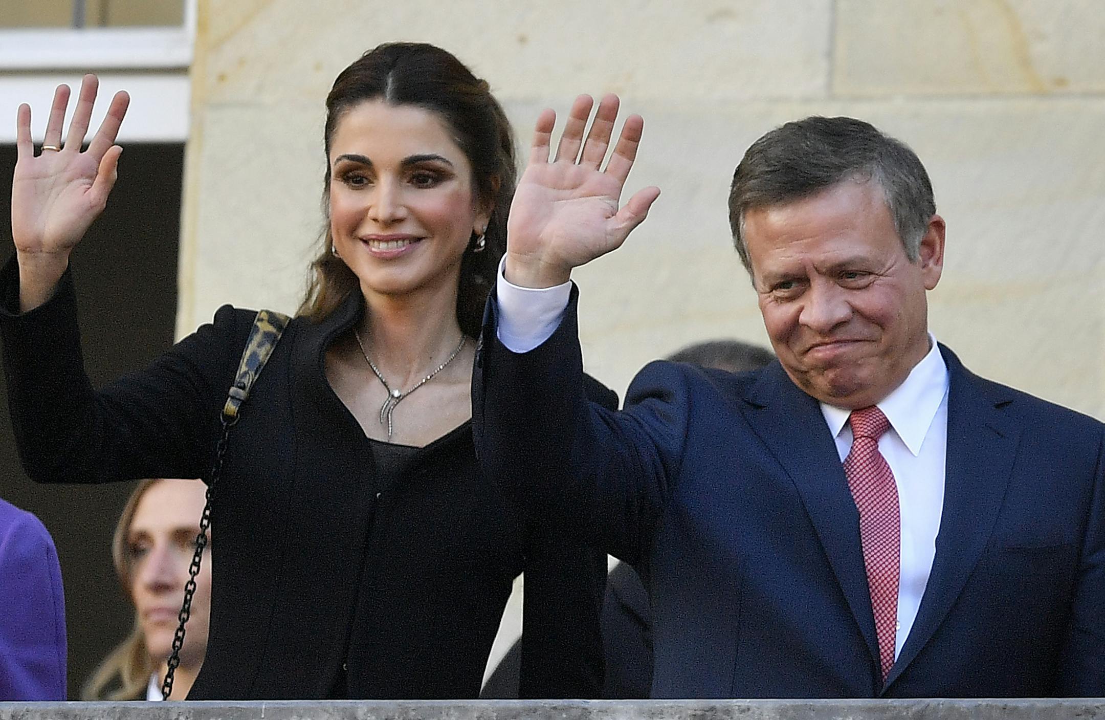 King Abdullah of Jordan and Queen Rania wave to citizens on the historic town hall balcony in Muenster, Germany, Saturday, Oct. 8, 2016. King Abdullah was awarded the Peace Prize of Westphalia in recognition of his endeavors for peace and international security and stability. (AP Photo/Martin Meissner) ORG XMIT: MME104