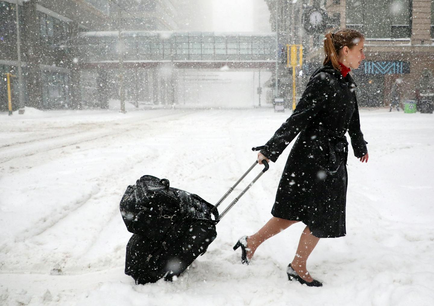 After her flight to Paris was grounded, Delta Air Lines flight attendant Victoria Flees slogged through snow with as much dignity as possible on Saturday. Blizzard conditions in the Twin Cities are making travel dangerous and bringing the metro area to a standstill.