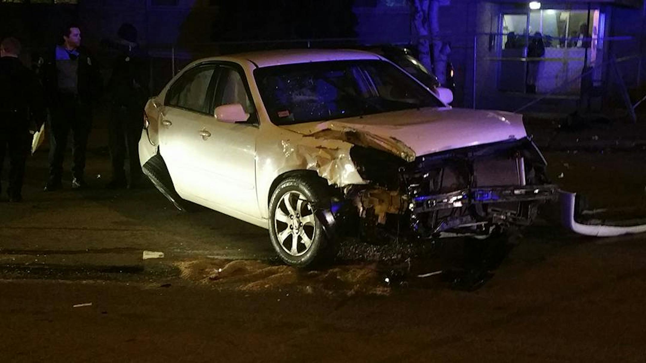 Two police officers and four other people were slightly hurt Monday evening when a Minneapolis squad car hit an apartment building after striking another vehicle.