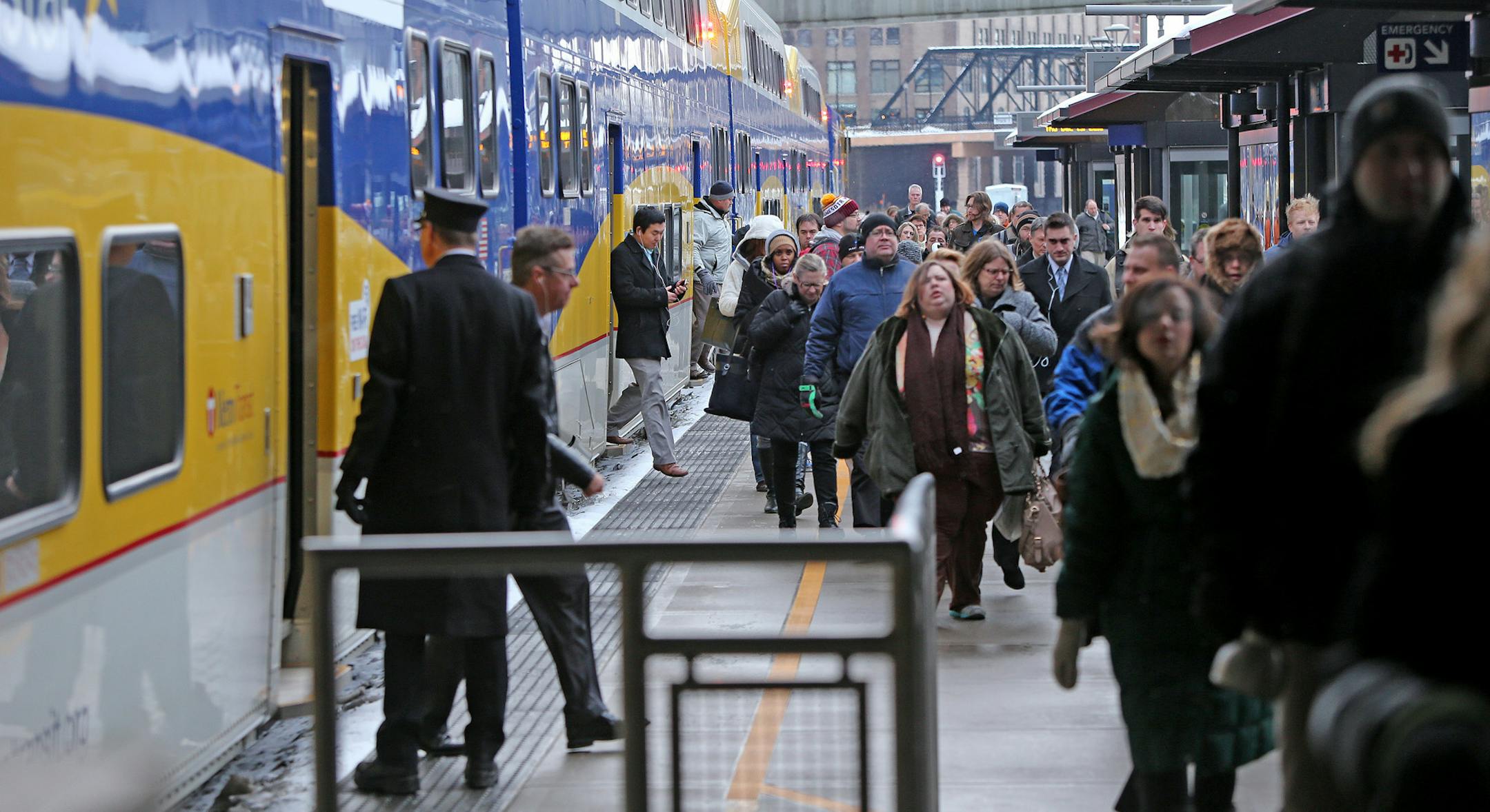 Northstar commuters made their way off the train at the Target Station about 50 minutes late, Thursday, December 19, 2013. The Northstar commuter rail from Big Lake into Minneapolis was running at least 30 minutes behind Friday morning because of heavy freight traffic along the line, which is owned by BNSF. (ELIZABETH FLORES/STAR TRIBUNE) ELIZABETH FLORES • eflores@startribune.com