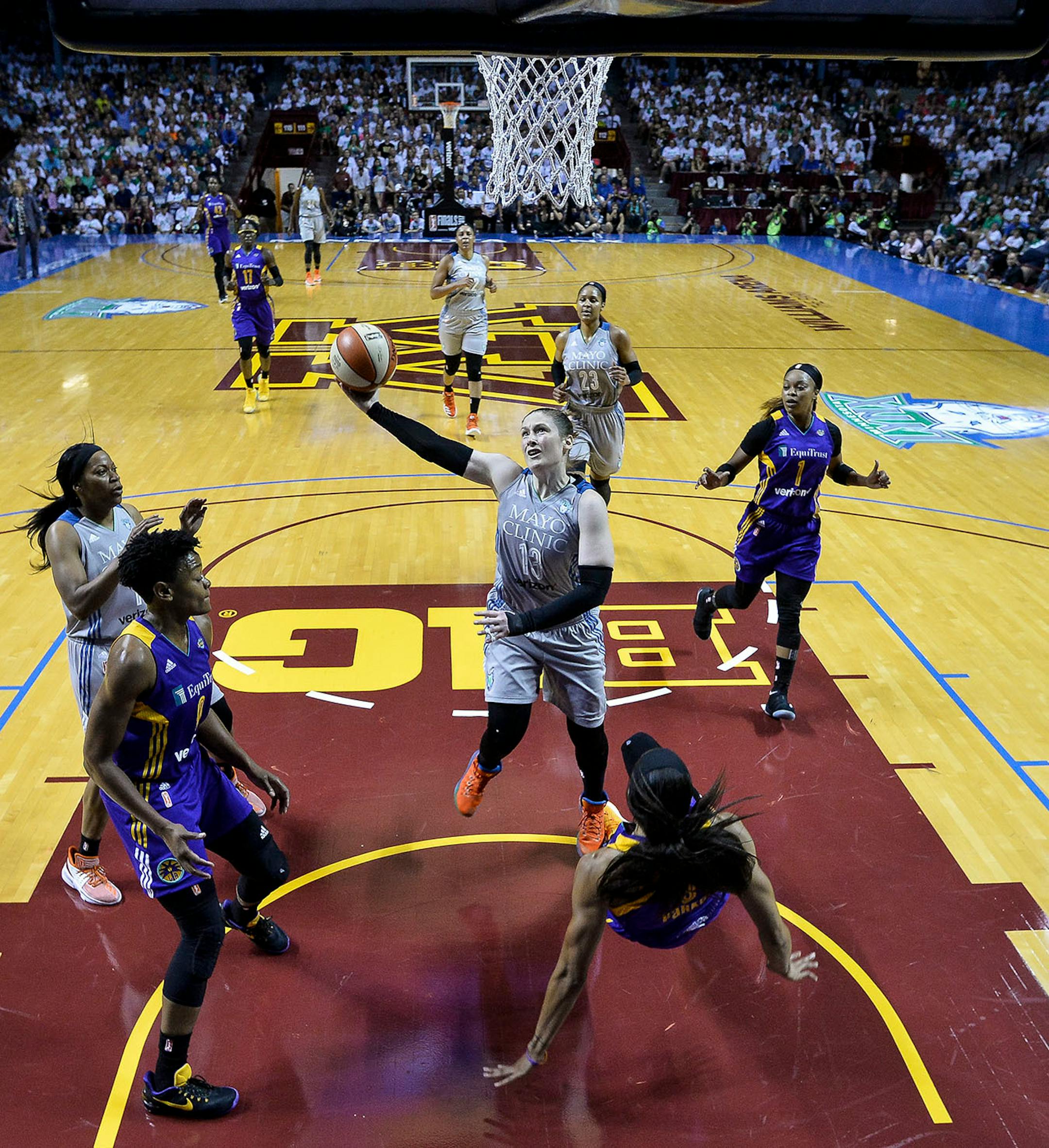 Minnesota Lynx guard Lindsay Whalen (13) scored a layup and an and-one after being fouled by Los Angeles Sparks forward Candace Parker (3) in the second quarter.