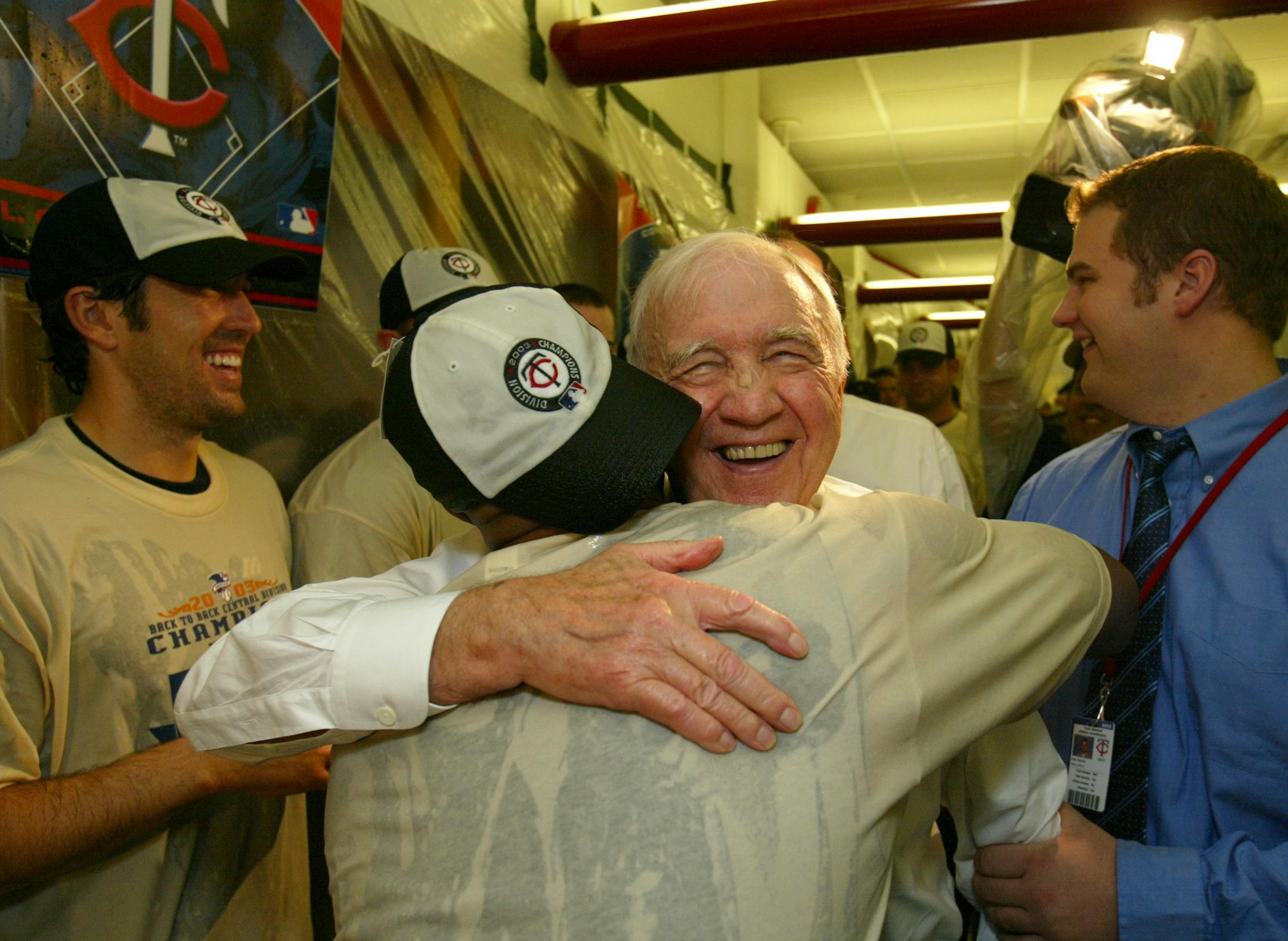 Torii Hunter gave champagne-drenched Twins owner Carl Pohlad a hug in the locker room after their division clinching win in 2003.