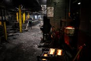 A worker sweeps up silica sand around casting molds at Smith Foundry Tuesday, Dec. 12, 2023 Minneapolis, Minn. For years, residents have been complain